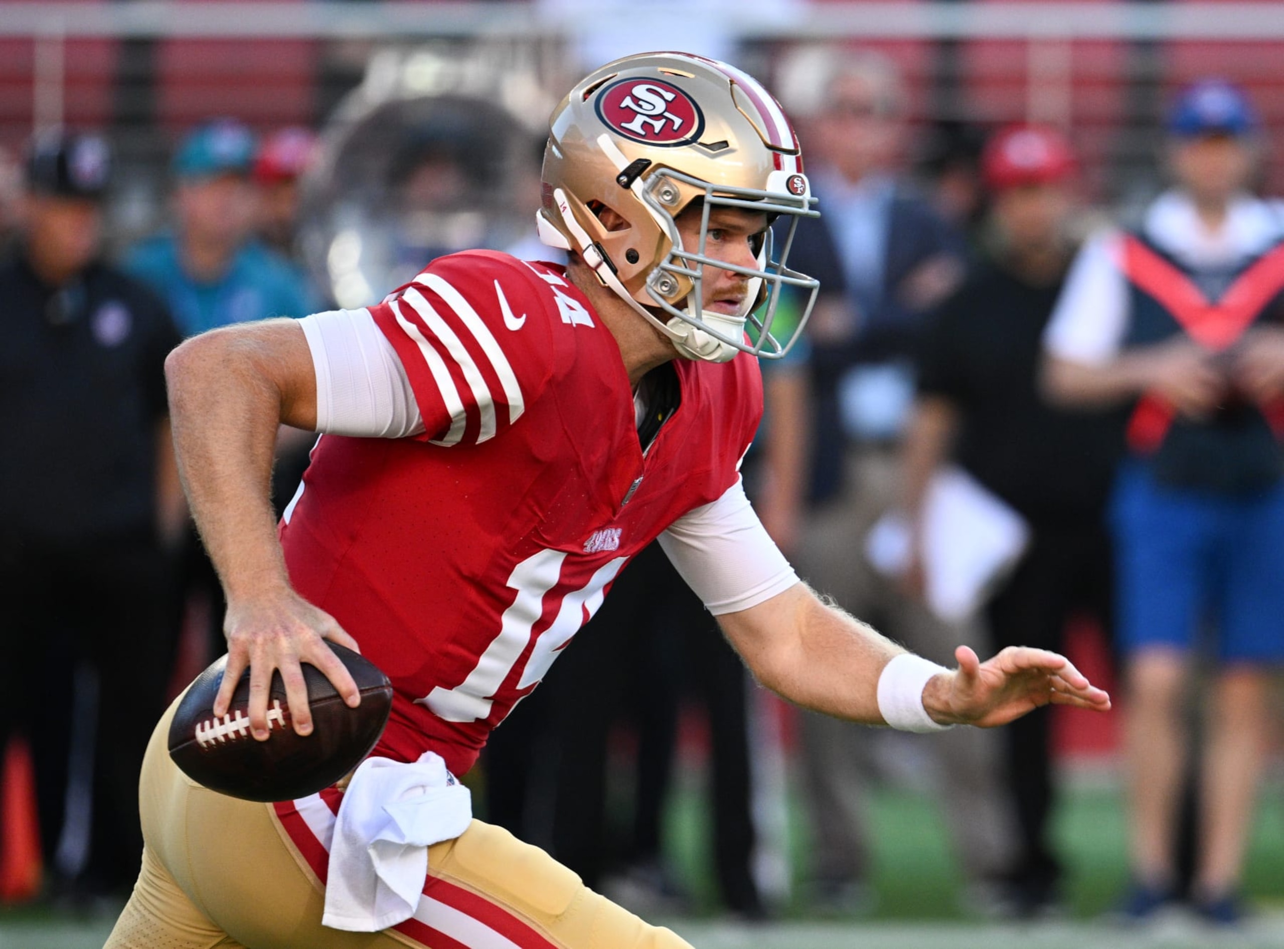 SANTA CLARA, CALIFORNIA - AUGUST 19: Sam Darnold #14 of the San Francisco 49ers scrambles during the first half of a preseason game against the Denver Broncos at Levi's Stadium on August 19, 2023 in Santa Clara, California. (Photo by Loren Elliott/Getty Images)