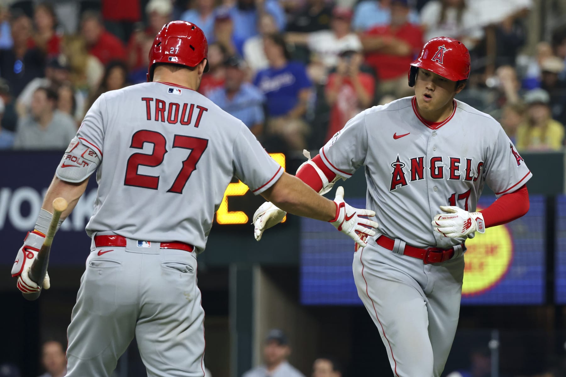 Los Angeles Angels' Shohei Ohtani, right, celebrates with Mike Trout (27) after hitting a two-run home run in the eighth inning in a baseball game against the Texas Rangers, Thursday, June 15, 2023, in Arlington, Texas. (AP Photo/Richard W. Rodriguez)