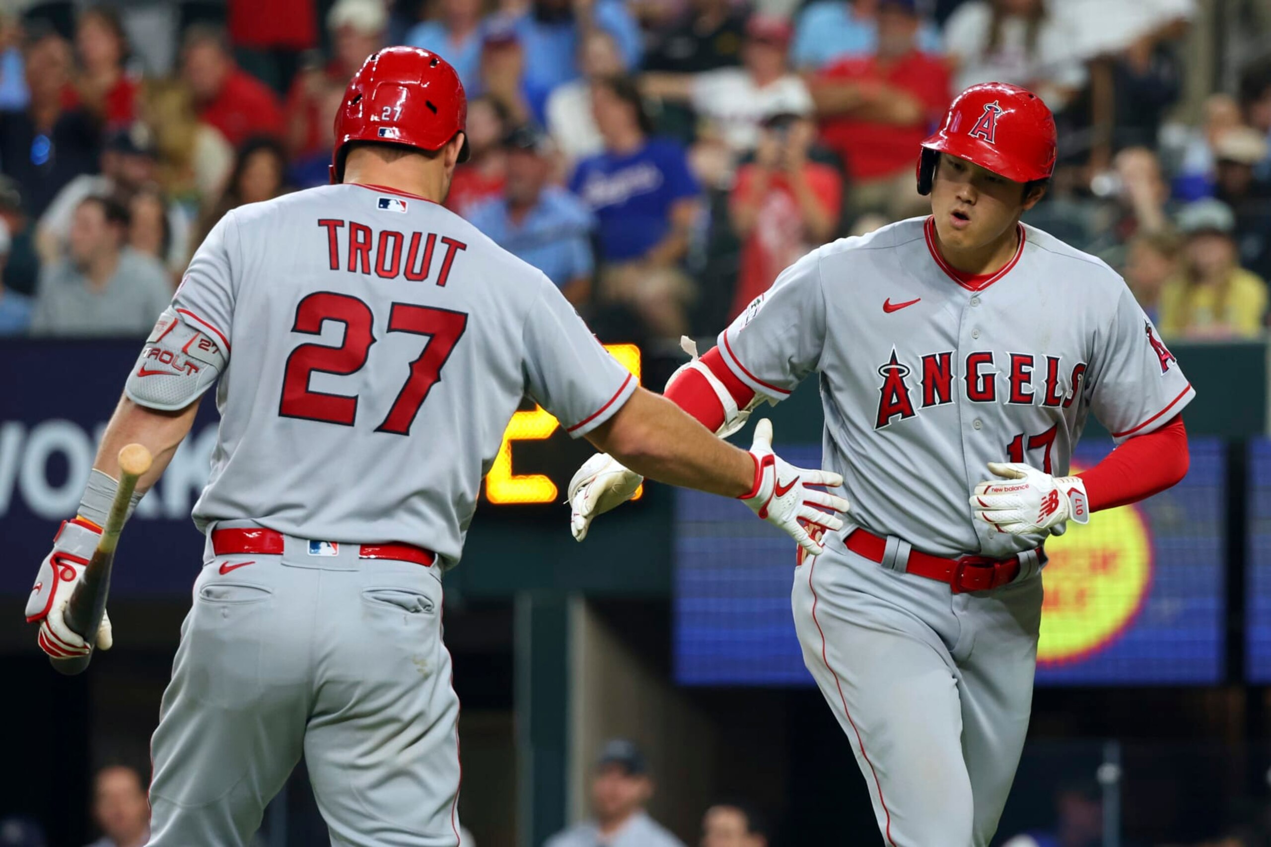 Los Angeles Angels' Shohei Ohtani, right, celebrates with Mike Trout (27) after hitting a two-run home run in the eighth inning in a baseball game against the Texas Rangers, Thursday, June 15, 2023, in Arlington, Texas. (AP Photo/Richard W. Rodriguez)