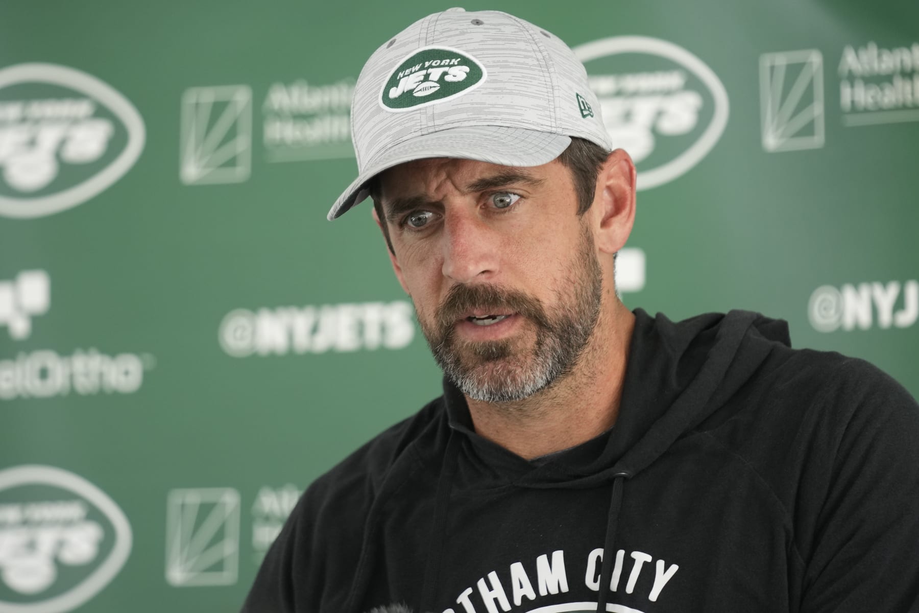 New York Jets quarterback Aaron Rodgers talks to reporters after a joint practice with the Tampa Bay Buccaneers at the Jets' training facility in Florham Park, N.J., Wednesday, Aug. 16, 2023. (AP Photo/Seth Wenig)