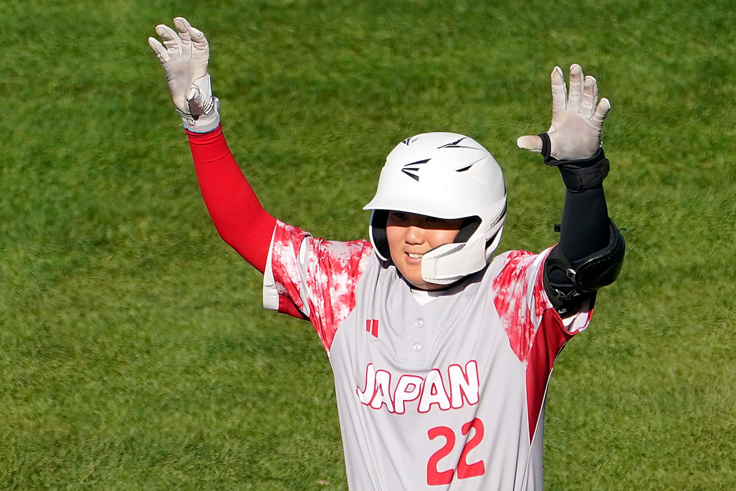 Japan's Nobuaki Sakaue celebrates standing on first base after driving in two runs against Panama during the first inning of a baseball game at the Little League World Series tournament in South Williamsport, Pa., Tuesday, Aug. 22, 2023. (AP Photo/Tom E. Puskar)