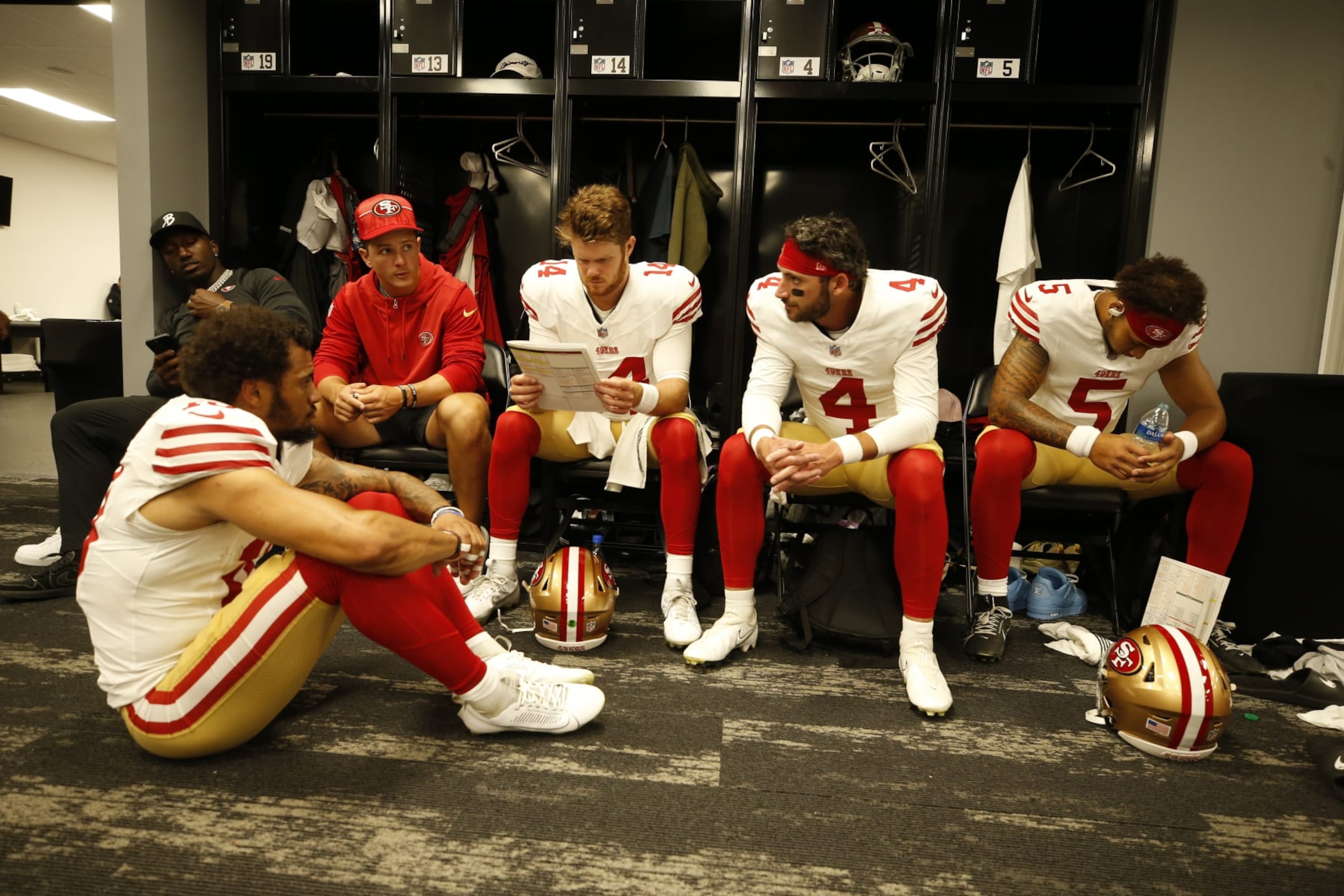 LAS VEGAS, NV - AUGUST 13: Deebo Samuel #19, Brock Purdy #13, Sam Darnold #14, Brandon Allen #4 and Trey Lance #5 of the San Francisco 49ers in the locker room before the game against the Las Vegas Raiders at Allegiant Stadium on August 13, 2023 in Las Vegas, Nevada. The Raiders defeated the 49ers 34-7. (Photo by Michael Zagaris/San Francisco 49ers/Getty Images)