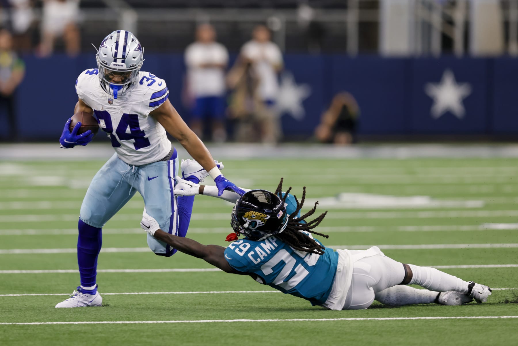 ARLINGTON, TX - AUGUST 12: Dallas Cowboys running back Malik Davis (34) gets tackled by Jacksonville Jaguars cornerback Tevaughn Campbell (29) during the preseason game between the Dallas Cowboys and the Jacksonville Jaguars on August 12, 2023 at AT&T Stadium in Arlington, Texas. (Photo by Matthew Pearce/Icon Sportswire via Getty Images)