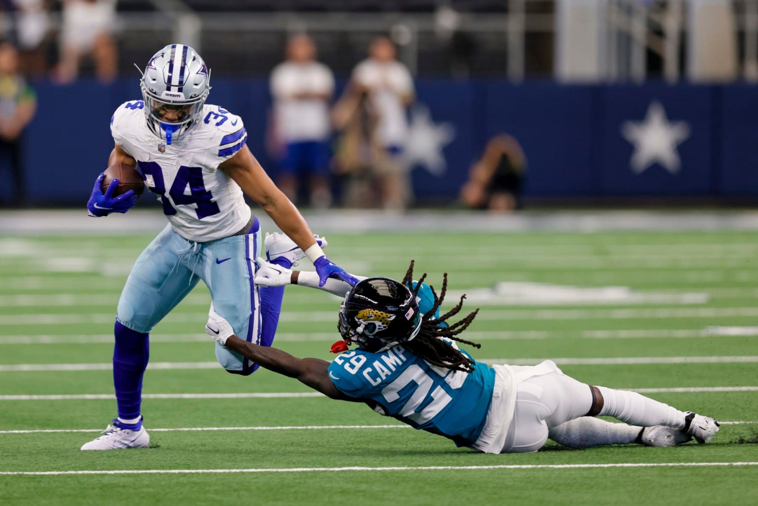 ARLINGTON, TX - AUGUST 12: Dallas Cowboys running back Malik Davis (34) gets tackled by Jacksonville Jaguars cornerback Tevaughn Campbell (29) during the preseason game between the Dallas Cowboys and the Jacksonville Jaguars on August 12, 2023 at AT&T Stadium in Arlington, Texas. (Photo by Matthew Pearce/Icon Sportswire via Getty Images)