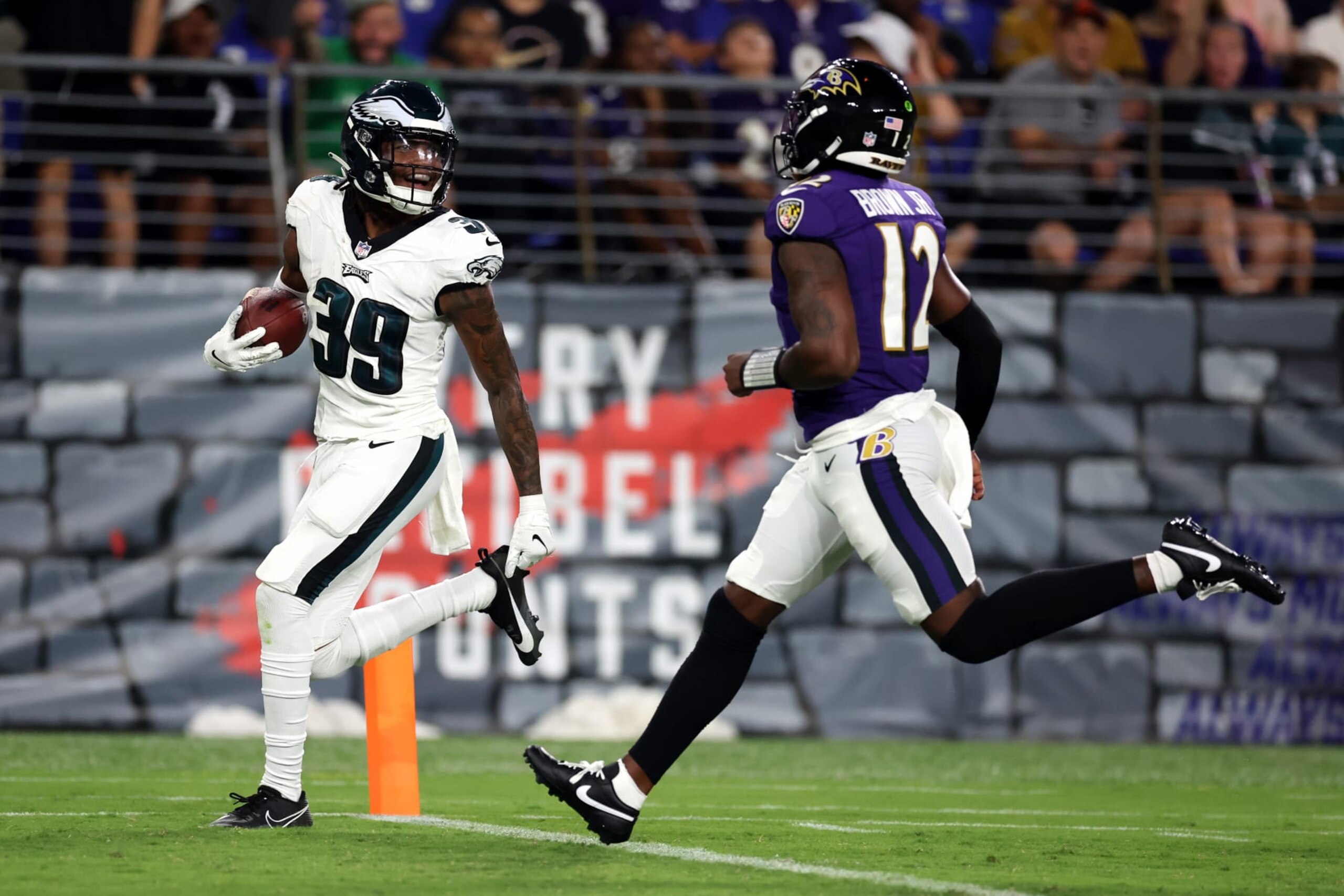 BALTIMORE, MARYLAND - AUGUST 12: Cornerback Eli Ricks #39 of the Philadelphia Eagles celebrates in front of quarterback Anthony Brown #12 of the Baltimore Ravens after intercepting a pass for a touchdown in the second half of preseason game at M&T Bank Stadium on August 12, 2023 in Baltimore, Maryland. (Photo by Rob Carr/Getty Images)