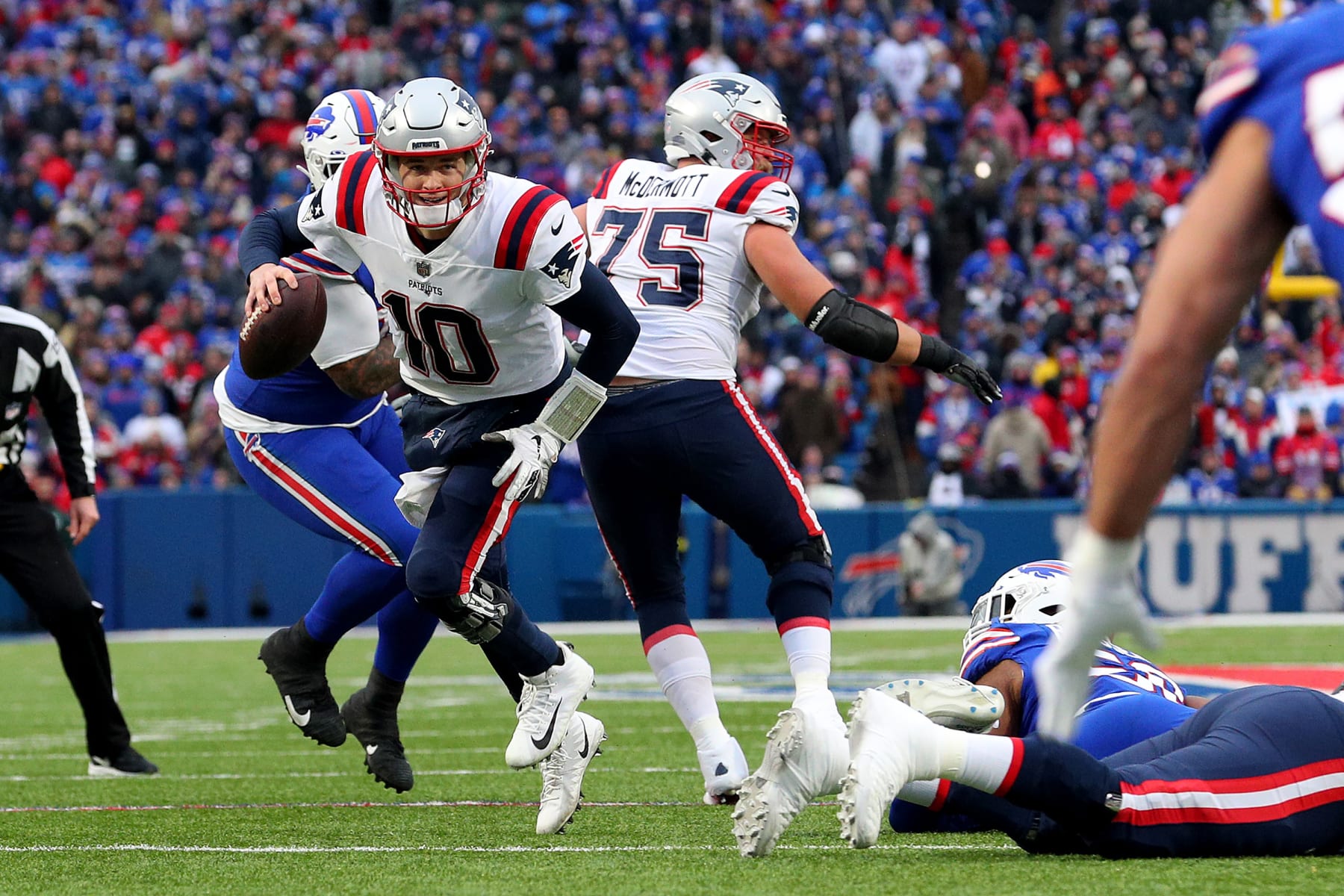 ORCHARD PARK, NEW YORK - JANUARY 08: Mac Jones #10 of the New England Patriots runs the ball during the third quarter against the Buffalo Bills at Highmark Stadium on January 08, 2023 in Orchard Park, New York. (Photo by Bryan Bennett/Getty Images)