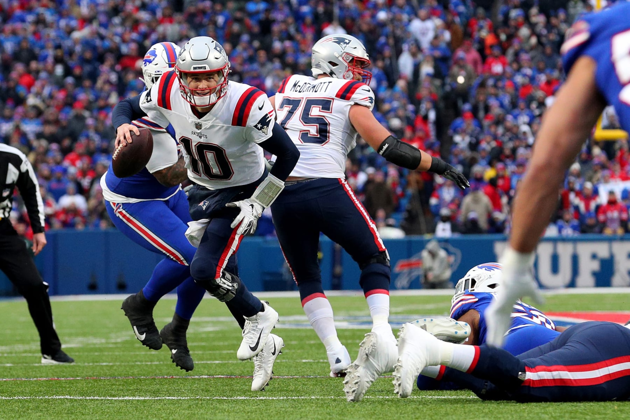 ORCHARD PARK, NEW YORK - JANUARY 08: Mac Jones #10 of the New England Patriots runs the ball during the third quarter against the Buffalo Bills at Highmark Stadium on January 08, 2023 in Orchard Park, New York. (Photo by Bryan Bennett/Getty Images)