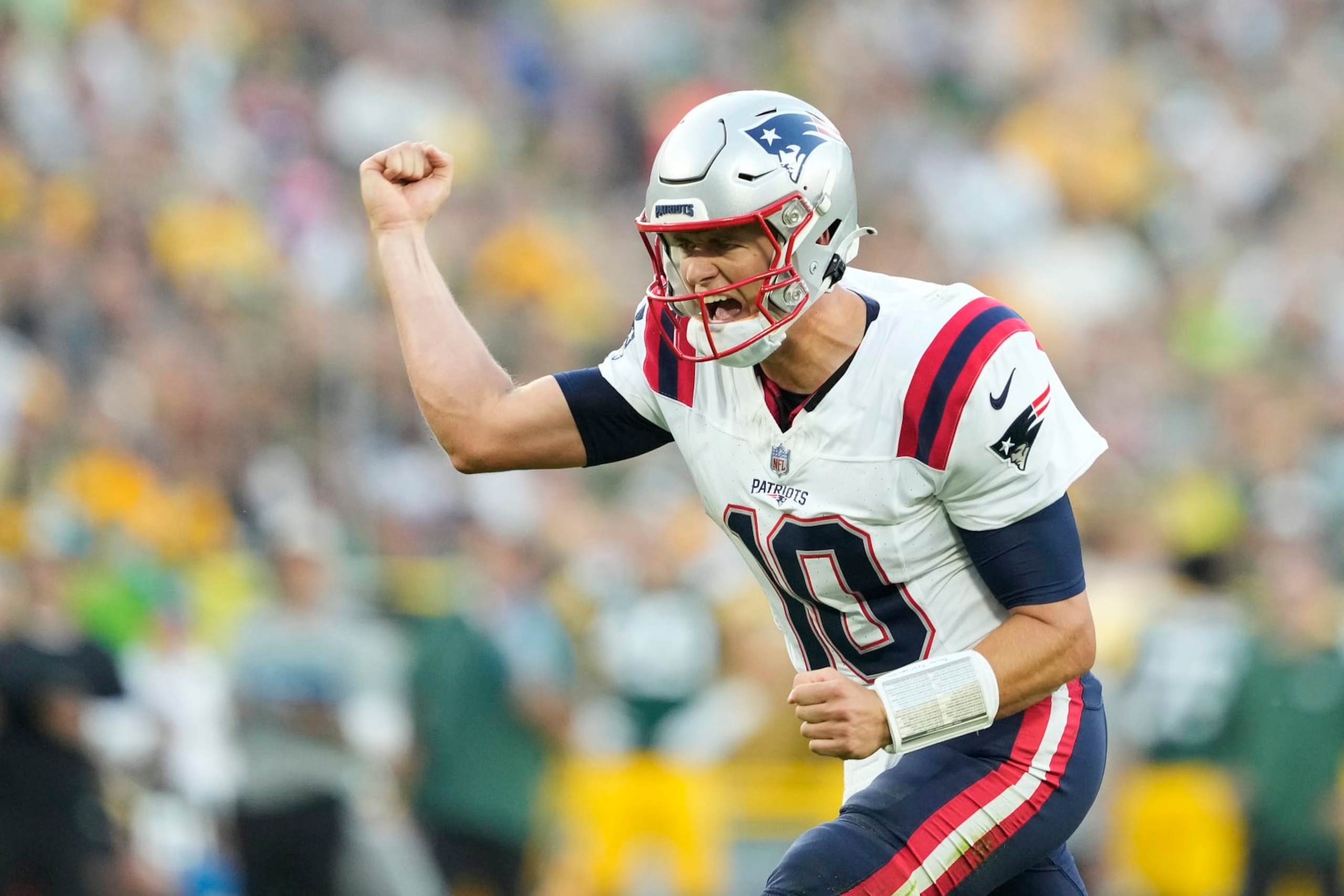 GREEN BAY, WISCONSIN - AUGUST 19: Mac Jones #10 of the New England Patriots celebrates after a touchdown in the first quarter against the Green Bay Packers during a preseason game at Lambeau Field on August 19, 2023 in Green Bay, Wisconsin. (Photo by Patrick McDermott/Getty Images)