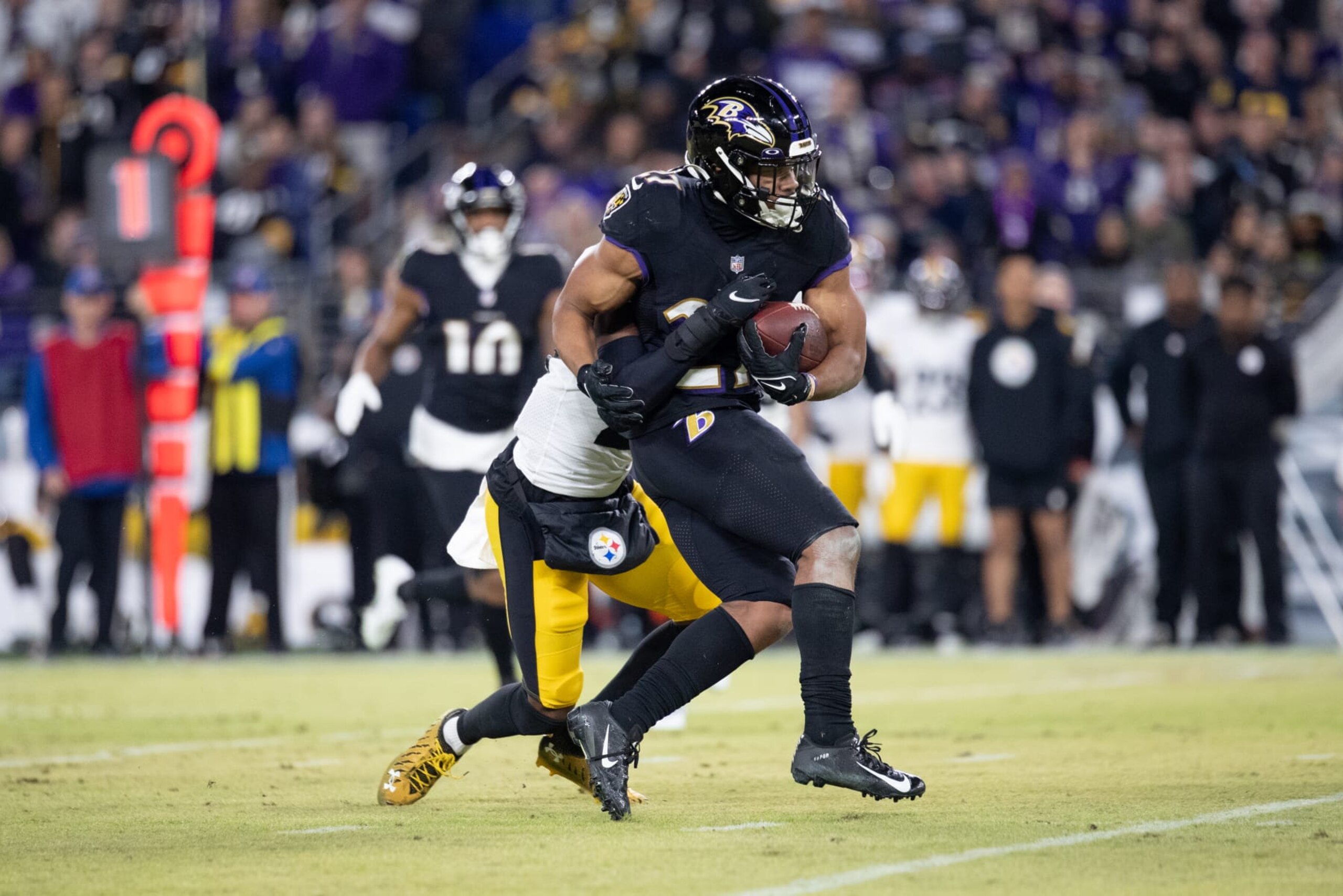 BALTIMORE, MD - JANUARY 01: Baltimore Ravens running back J.K. Dobbins (27) carries a Pittsburgh Steelers defender during the game between the Pittsburgh Steelers and the Baltimore Ravens on January 1, 2023 at M&T Bank Stadium in Baltimore, MD. (Photo by Charles Brock/Icon Sportswire via Getty Images)