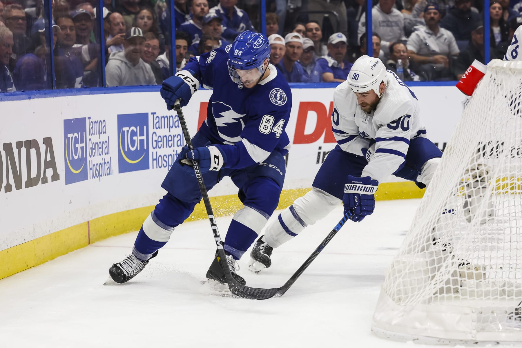 TAMPA, FL - APRIL 24: Tanner Jeannot #84 of the Tampa Bay Lightning battles against Ryan O'Reilly #90 of the Toronto Maple Leafs during the first period in Game Four of the First Round of the 2023 Stanley Cup Playoffs at Amalie Arena on April 24, 2023 in Tampa, Florida. (Photo by Mark LoMoglio/NHLI via Getty Images)