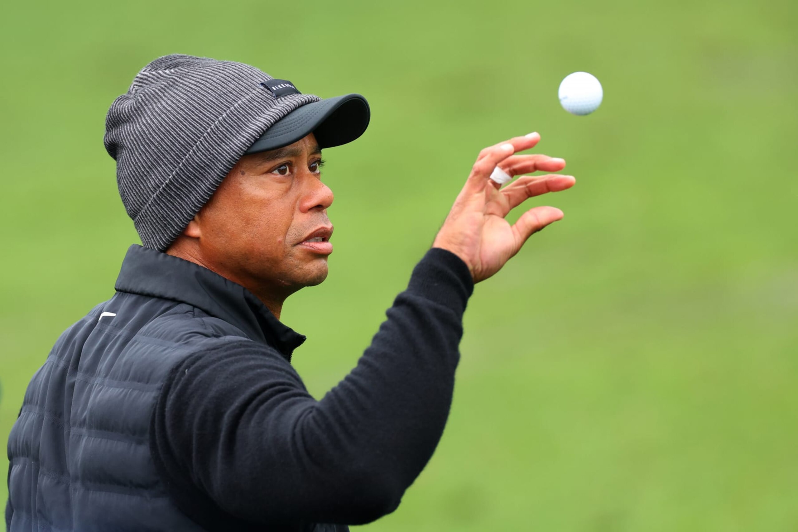 AUGUSTA, GEORGIA - APRIL 08: Tiger Woods of the United States catches a ball on the practice area during the third round of the 2023 Masters Tournament at Augusta National Golf Club on April 08, 2023 in Augusta, Georgia. (Photo by Andrew Redington/Getty Images)