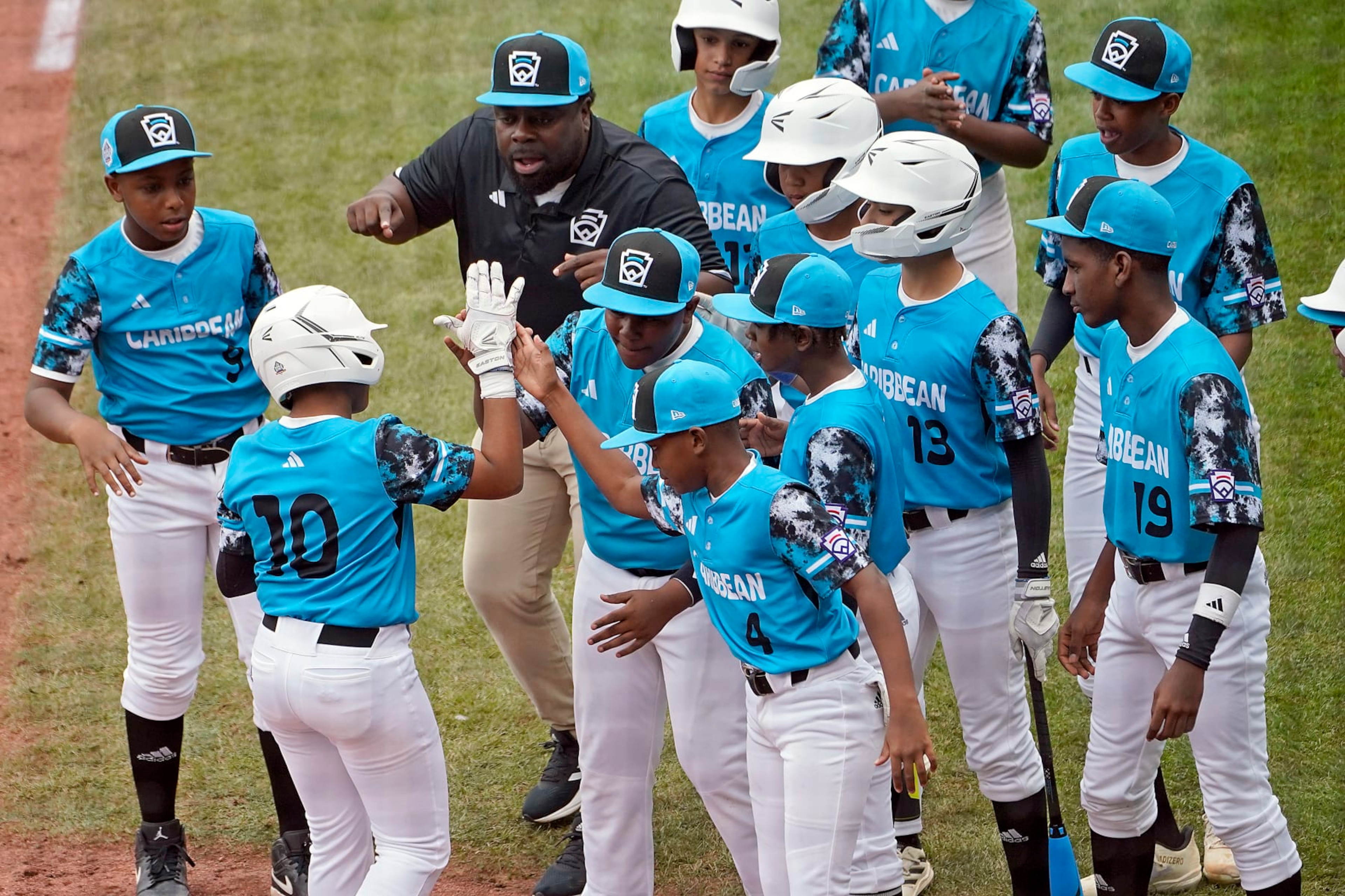 Curacao's Jay-Dlynn Wiel (10) celebrates with his teammates on the way back to the dugout after his home run off of Taiwan starting pitcher Cai Yuan-Hao during the first inning of a baseball game at the Little League World Series tournament in South Williamsport, Pa., Wednesday, Aug. 23, 2023. (AP Photo/Tom E. Puskar) Curacao's Jay-Dlynn Wiel (10) celebrates with his teammates on the way back to the dugout after his home run off of Taiwan starting pitcher Cai Yuan-Hao during the first inning of a baseball game at the Little League World Series tournament in South Williamsport, Pa., Wednesday, Aug. 23, 2023. (AP Photo/Tom E. Puskar)