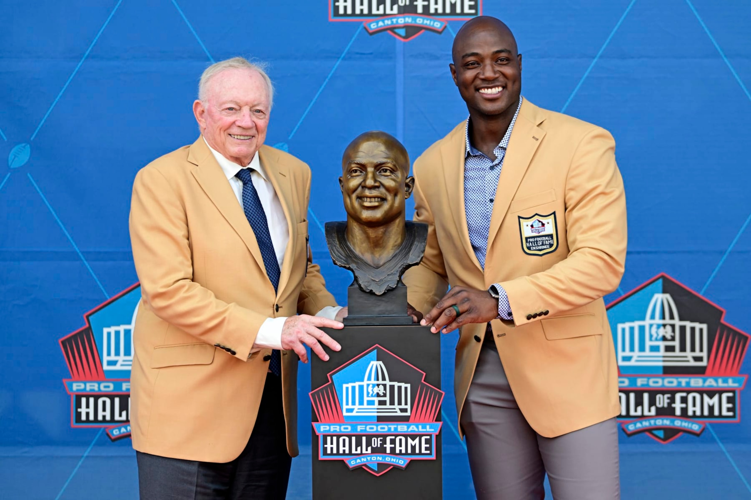 Former NFL player DeMarcus Ware, right, and Dallas Cowboys owner Jerry Jones pose with Ware's bust during his induction into the Pro Football Hall of Fame in Canton, Ohio, Saturday, Aug. 5, 2023. (AP Photo/David Dermer)