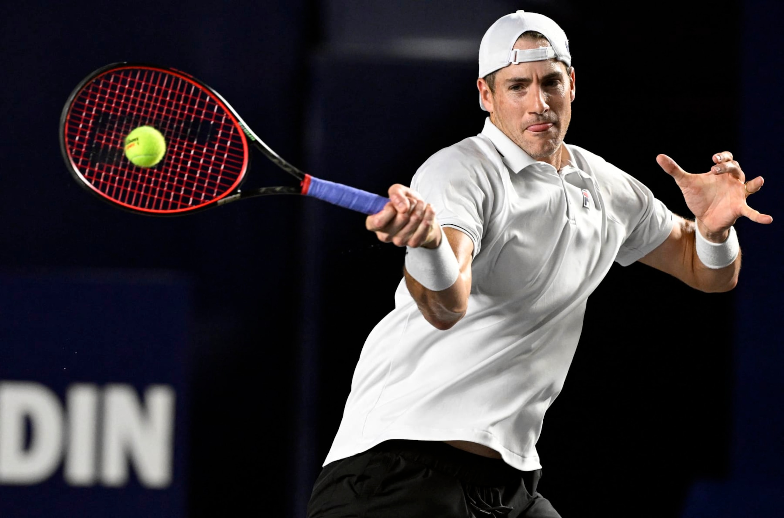 USA's John Isner plays a forehand return to Greece's Stefanos Tsitsipas during their Mexico ATP Open 250 men's singles round of 16 tennis match at Cabo Sports Complex in Los Cabos, Baja California, Mexico, on August 3, 2023. (Photo by ALFREDO ESTRELLA / AFP) (Photo by ALFREDO ESTRELLA/AFP via Getty Images)