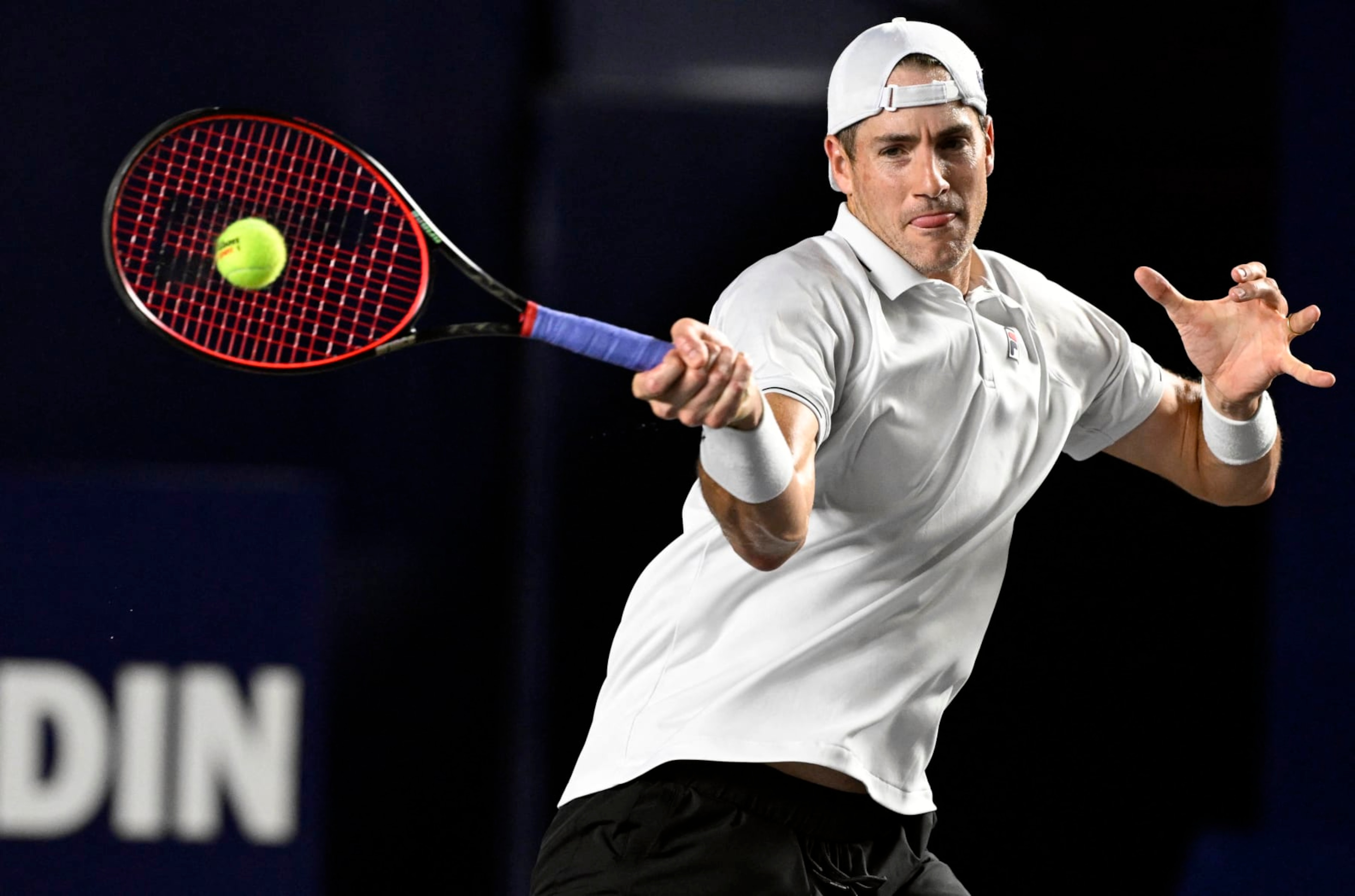 USA's John Isner plays a forehand return to Greece's Stefanos Tsitsipas during their Mexico ATP Open 250 men's singles round of 16 tennis match at Cabo Sports Complex in Los Cabos, Baja California, Mexico, on August 3, 2023. (Photo by ALFREDO ESTRELLA / AFP) (Photo by ALFREDO ESTRELLA/AFP via Getty Images)
