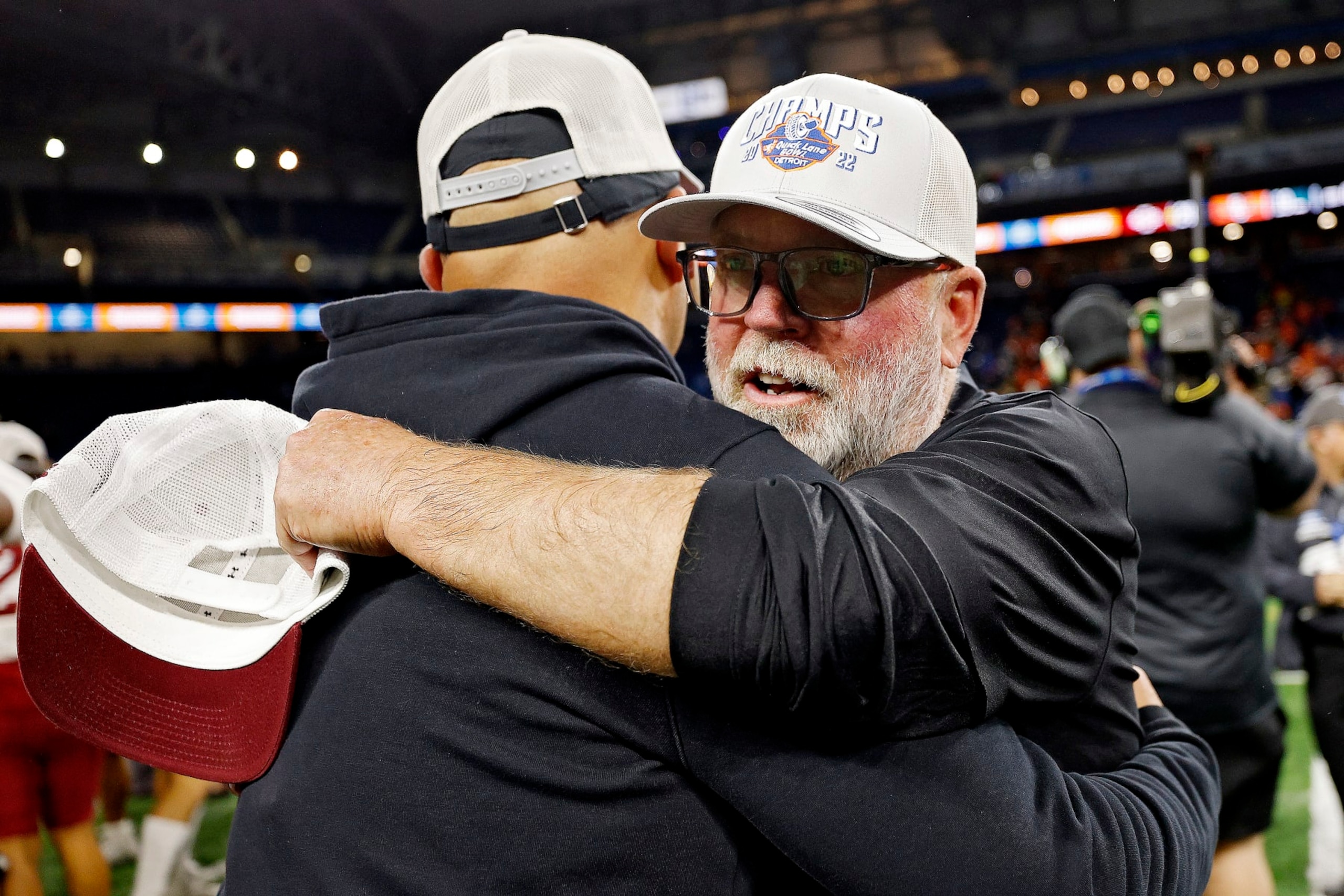 DETROIT, MICHIGAN - DECEMBER 26: Jerry Kill head coach of the New Mexico State Aggies hugs an assistant coach after the Aggied defeated the Bowling Green Falcons, 24-19, in the Quick Lane Bowl at Ford Field on December 26, 2022 in Detroit, Michigan. (Photo by Mike Mulholland/Getty Images)