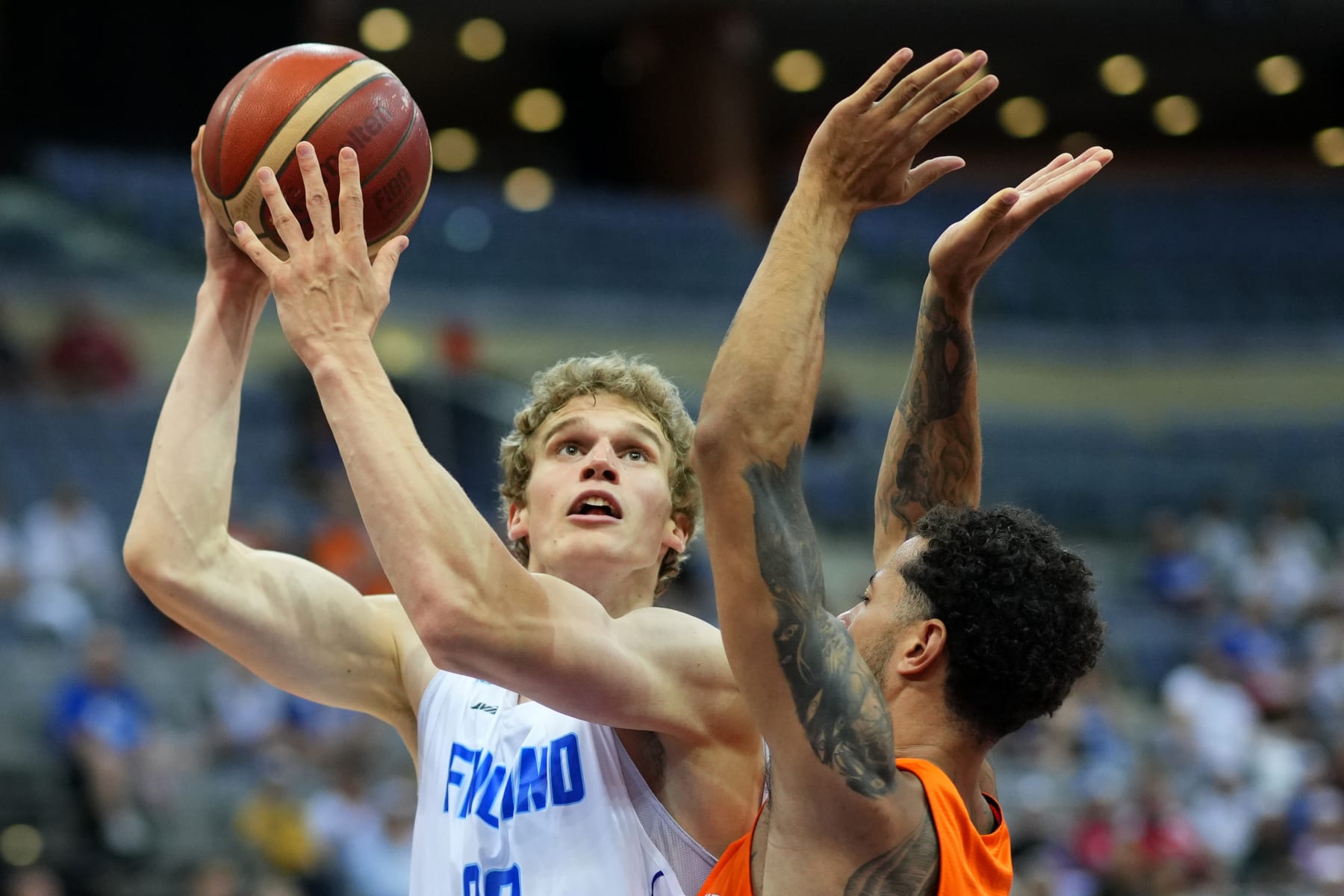 Netherlands' Jito Kok, right, challenges Finland's Lauri Markkanen during the Eurobasket group D basketball match between Finland and Netherlands in Prague, Czech Republic, Thursday, Sept. 8, 2022. (AP Photo/Petr David Josek)