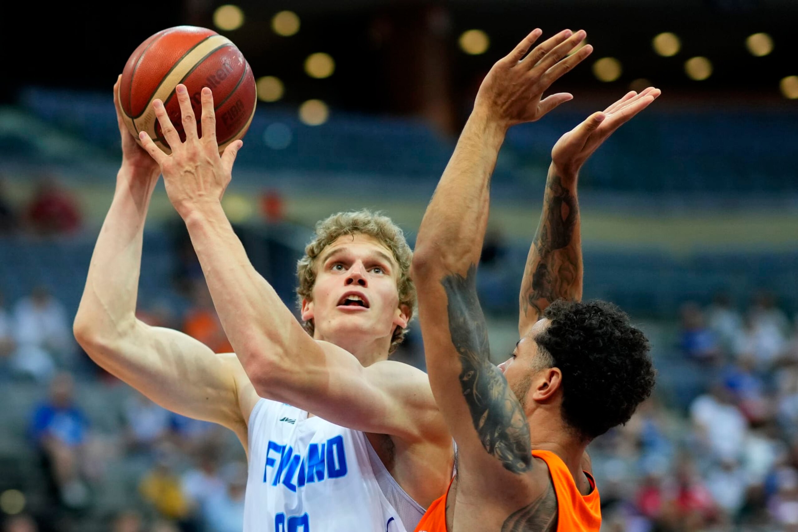 Netherlands' Jito Kok, right, challenges Finland's Lauri Markkanen during the Eurobasket group D basketball match between Finland and Netherlands in Prague, Czech Republic, Thursday, Sept. 8, 2022. (AP Photo/Petr David Josek)