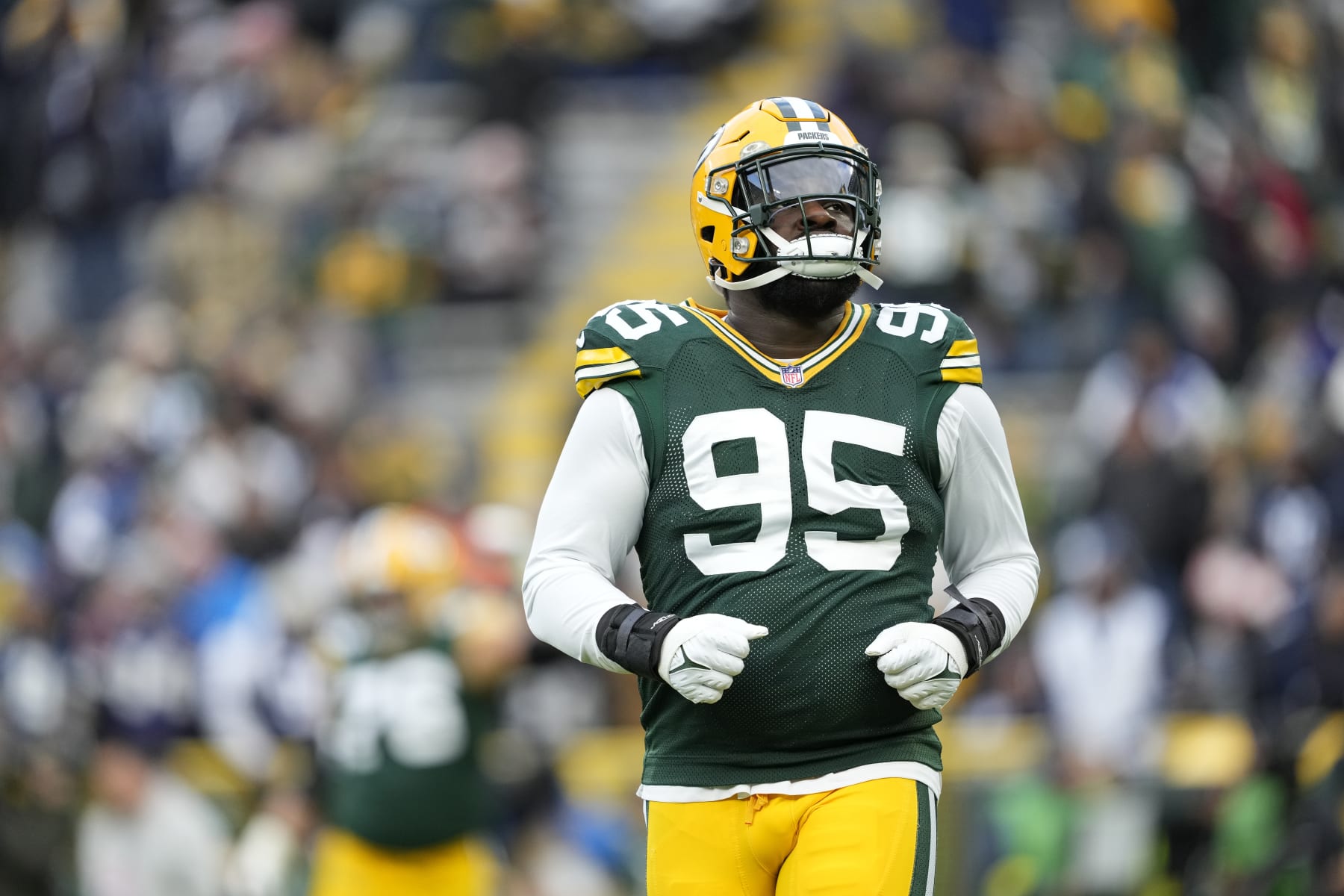 GREEN BAY, WISCONSIN - NOVEMBER 13: Devonte Wyatt #95 of the Green Bay Packers looks on before a game against the Dallas Cowboys at Lambeau Field on November 13, 2022 in Green Bay, Wisconsin. (Photo by Patrick McDermott/Getty Images)