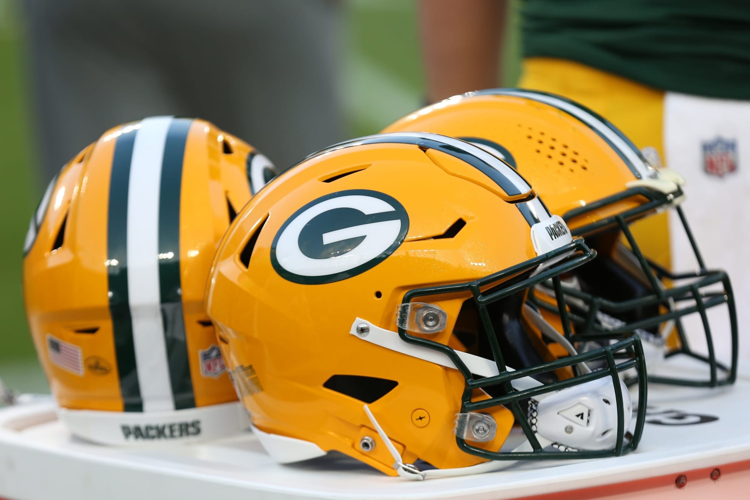 GREEN BAY, WI - AUGUST 19: Green Bay Packers helmets sit on the sideline during a game between the Green Bay Packers and the New England Patriots on August 19, 2023 in Green Bay, WI. (Photo by Larry Radloff/Icon Sportswire via Getty Images)