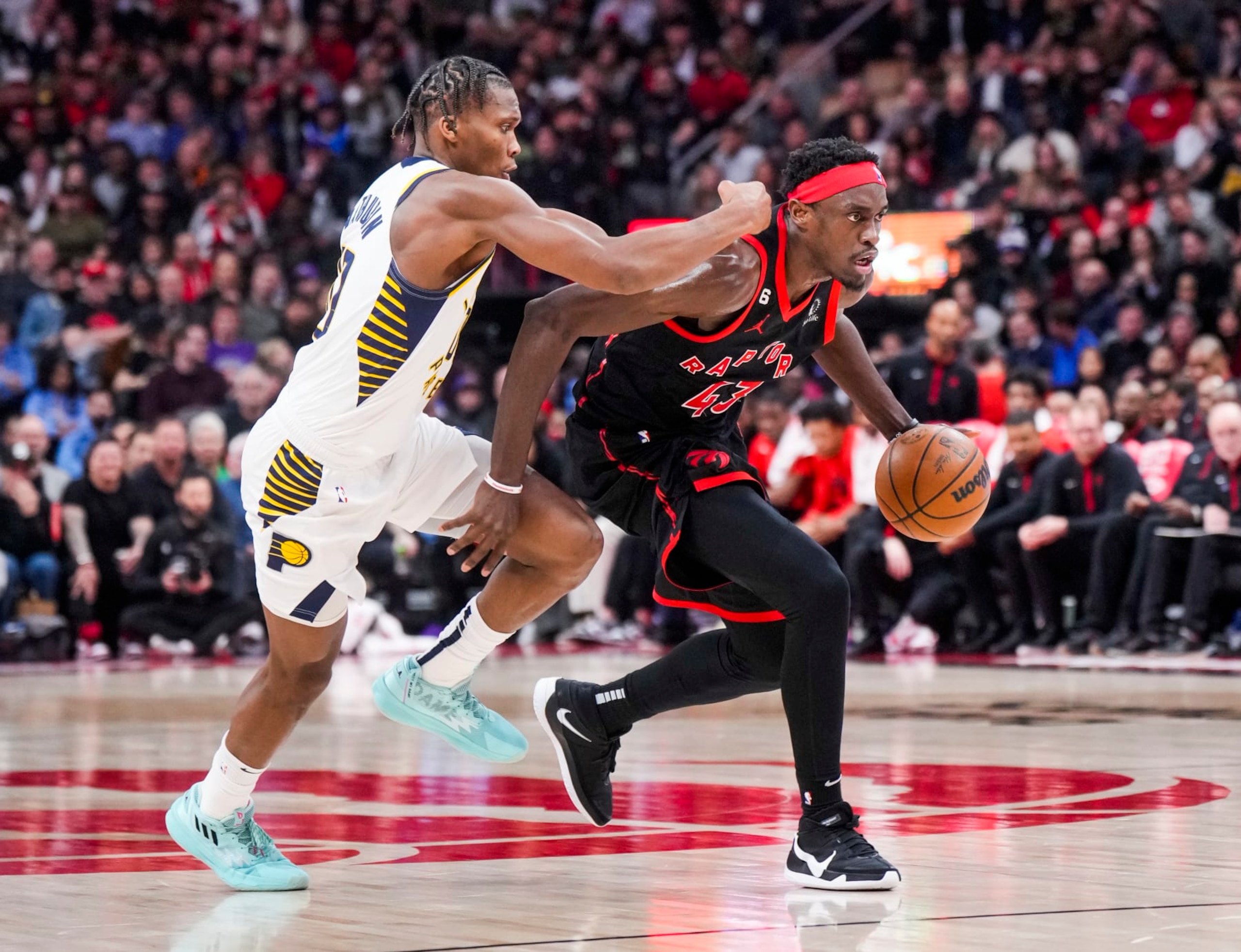 TORONTO, ON - MARCH 22: Pascal Siakam #43 of the Toronto Raptors drives against Bennedict Mathurin #00 of the Indiana Pacers of the Indiana Pacersduring the second half of their basketball game at the Scotiabank Arena on March 22, 2023 in Toronto, Ontario, Canada. NOTE TO USER: User expressly acknowledges and agrees that, by downloading and/or using this Photograph, user is consenting to the terms and conditions of the Getty Images License Agreement. (Photo by Mark Blinch/Getty Images)