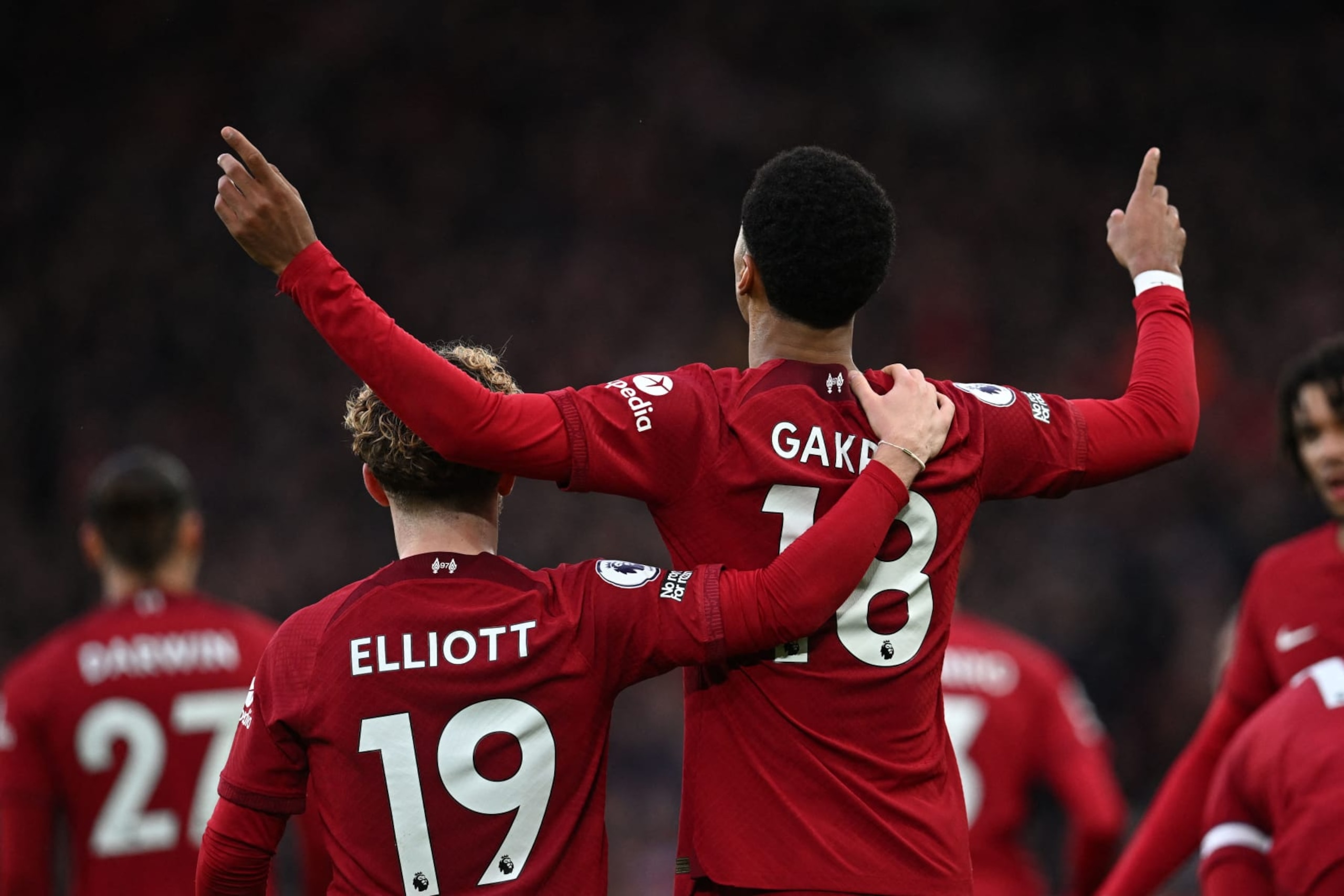 Liverpool's Dutch striker Cody Gakpo (C) celebrates with Liverpool's English midfielder Harvey Elliott (L) after scoring the opening goal of the English Premier League football match between Liverpool and Manchester United at Anfield in Liverpool, north west England on March 5, 2023. (Photo by Paul ELLIS / AFP) / RESTRICTED TO EDITORIAL USE. No use with unauthorized audio, video, data, fixture lists, club/league logos or 'live' services. Online in-match use limited to 120 images. An additional 40 images may be used in extra time. No video emulation. Social media in-match use limited to 120 images. An additional 40 images may be used in extra time. No use in betting publications, games or single club/league/player publications. /  (Photo by PAUL ELLIS/AFP via Getty Images)