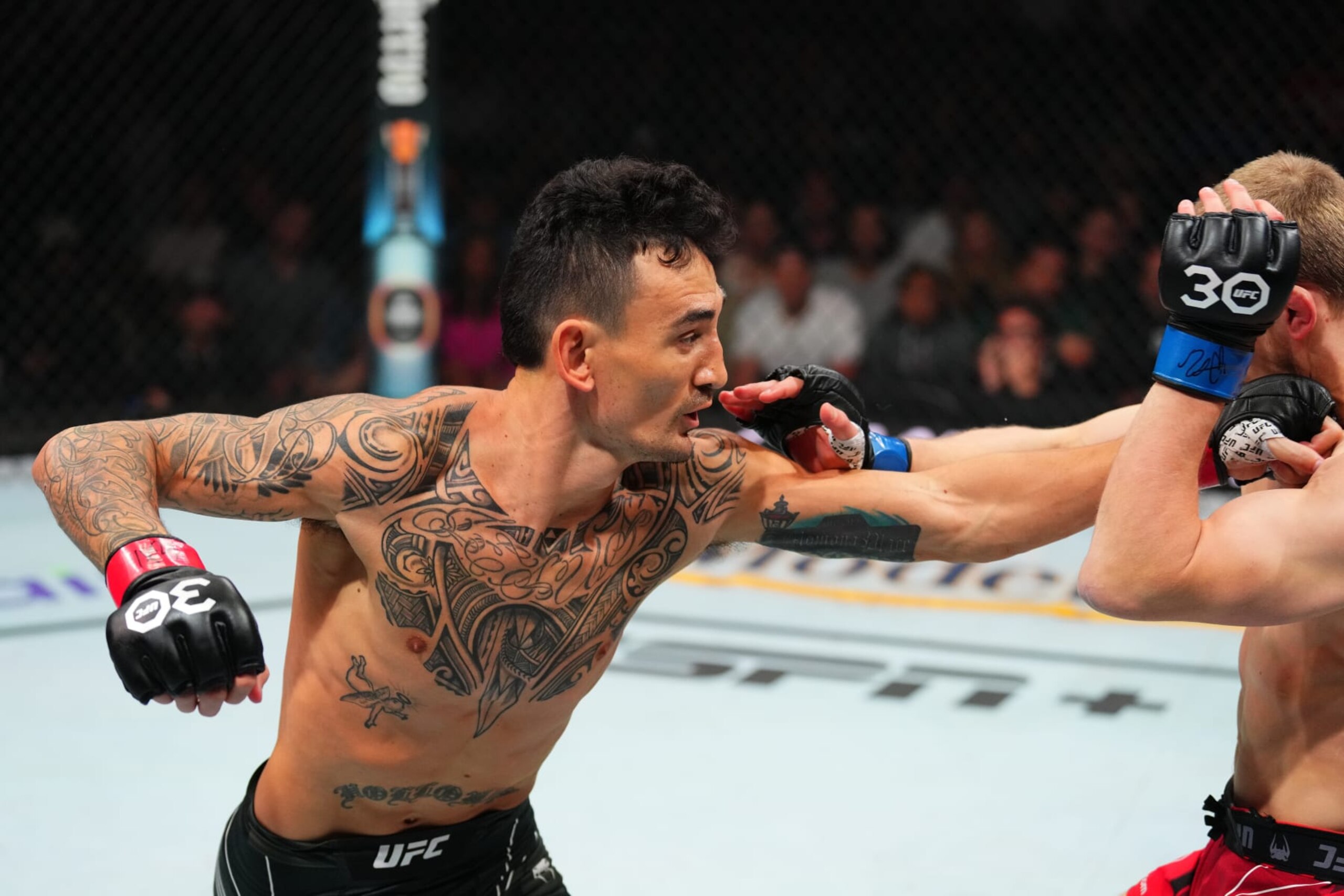 KANSAS CITY, MISSOURI - APRIL 15: (L-R) Max Holloway punches Arnold Allen of England in a featherweight fight during the UFC Fight Night event at T-Mobile Center on April 15, 2023 in Kansas City, Missouri. (Photo by Josh Hedges/Zuffa LLC via Getty Images) KANSAS CITY, MISSOURI - APRIL 15: (L-R) Max Holloway punches Arnold Allen of England in a featherweight fight during the UFC Fight Night event at T-Mobile Center on April 15, 2023 in Kansas City, Missouri. (Photo by Josh Hedges/Zuffa LLC via Getty Images)