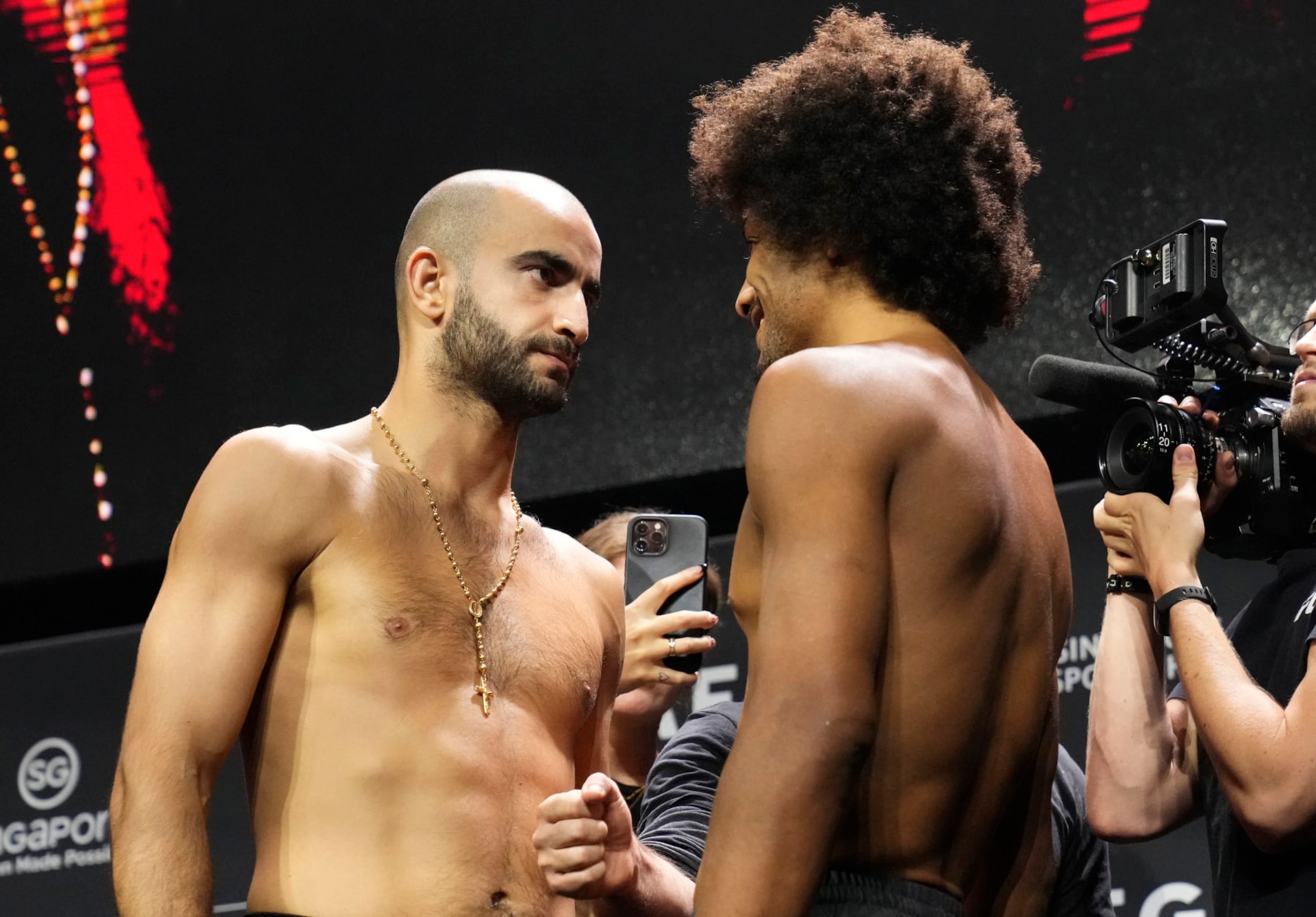 SINGAPORE, SINGAPORE - AUGUST 25: (L-R) Opponents Giga Chikadze of Georgia and Alex Caceres face off during the UFC Fight Night ceremonial weigh-in at Singapore Indoor Stadium on August 25, 2023 in Singapore. (Photo by Mike Roach/Zuffa LLC via Getty Images) SINGAPORE, SINGAPORE - AUGUST 25: (L-R) Opponents Giga Chikadze of Georgia and Alex Caceres face off during the UFC Fight Night ceremonial weigh-in at Singapore Indoor Stadium on August 25, 2023 in Singapore. (Photo by Mike Roach/Zuffa LLC via Getty Images)
