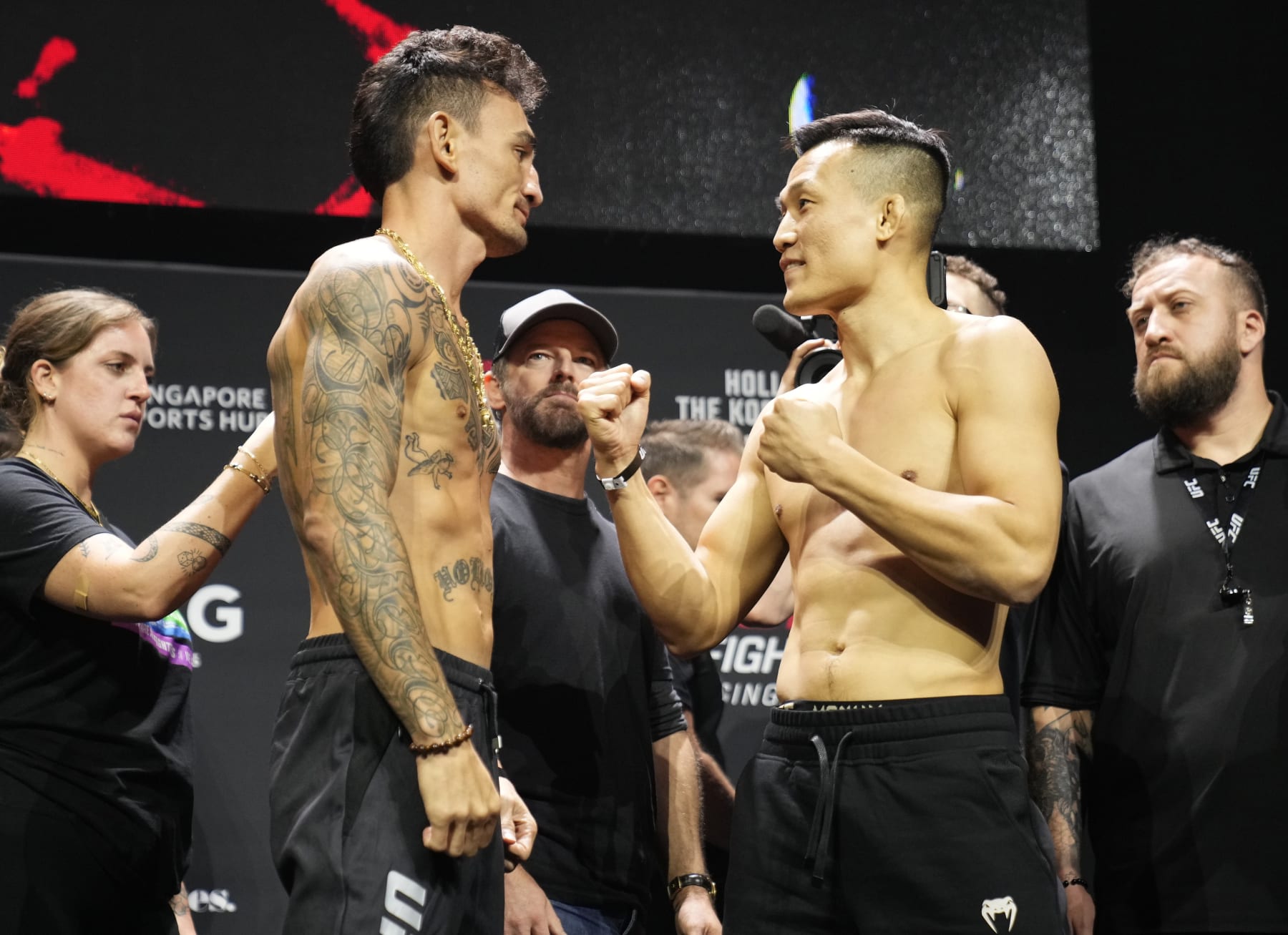 SINGAPORE, SINGAPORE - AUGUST 25: (L-R) Opponents Max Holloway and Chan Sung Jung of South Korea face off during the UFC Fight Night ceremonial weigh-in at Singapore Indoor Stadium on August 25, 2023 in Singapore. (Photo by Mike Roach/Zuffa LLC via Getty Images)