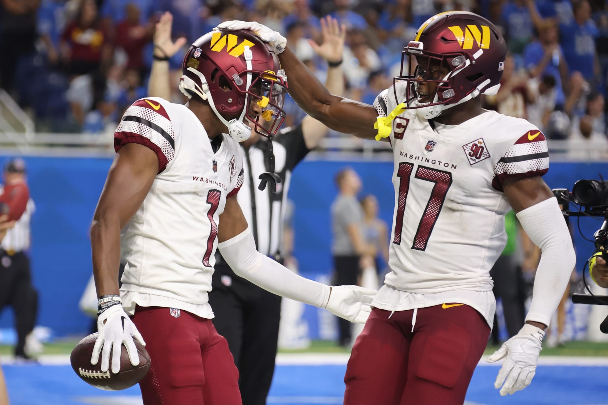 DETROIT, MICHIGAN - SEPTEMBER 18: Jahan Dotson #1 of the Washington Commanders (L) is congratulated by Terry McLaurin #17 after making a catch for a two-point conversion against the Detroit Lions during the fourth quarter at Ford Field on September 18, 2022 in Detroit, Michigan. (Photo by Gregory Shamus/Getty Images)