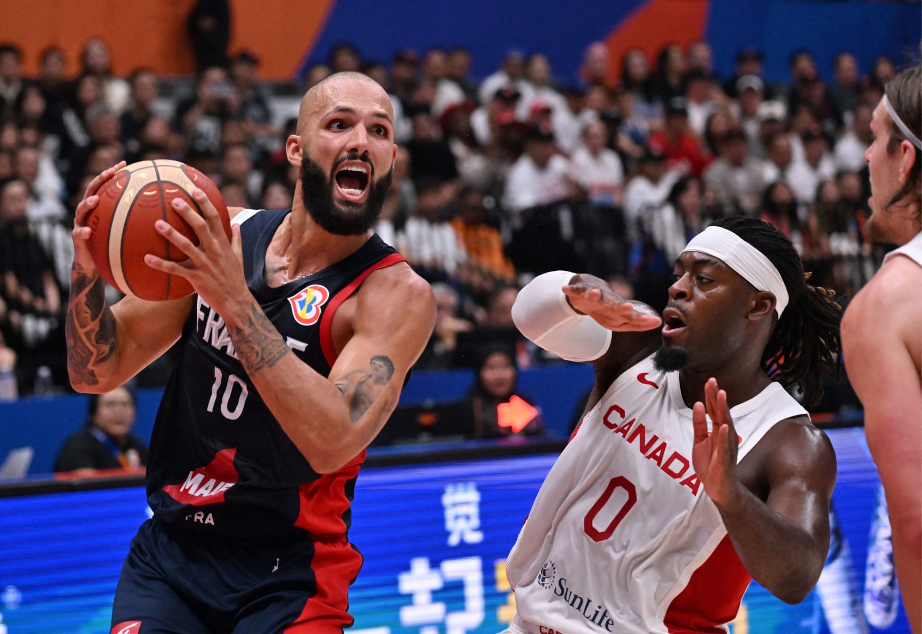 France's Evan Fournier (L) and Canada's Luguentz Dort vie for the ball during the FIBA Basketball World Cup group H match between France and Canada at Indonesia Arena in Jakarta on August 25, 2023. (Photo by ADEK BERRY / AFP) (Photo by ADEK BERRY/AFP via Getty Images)
