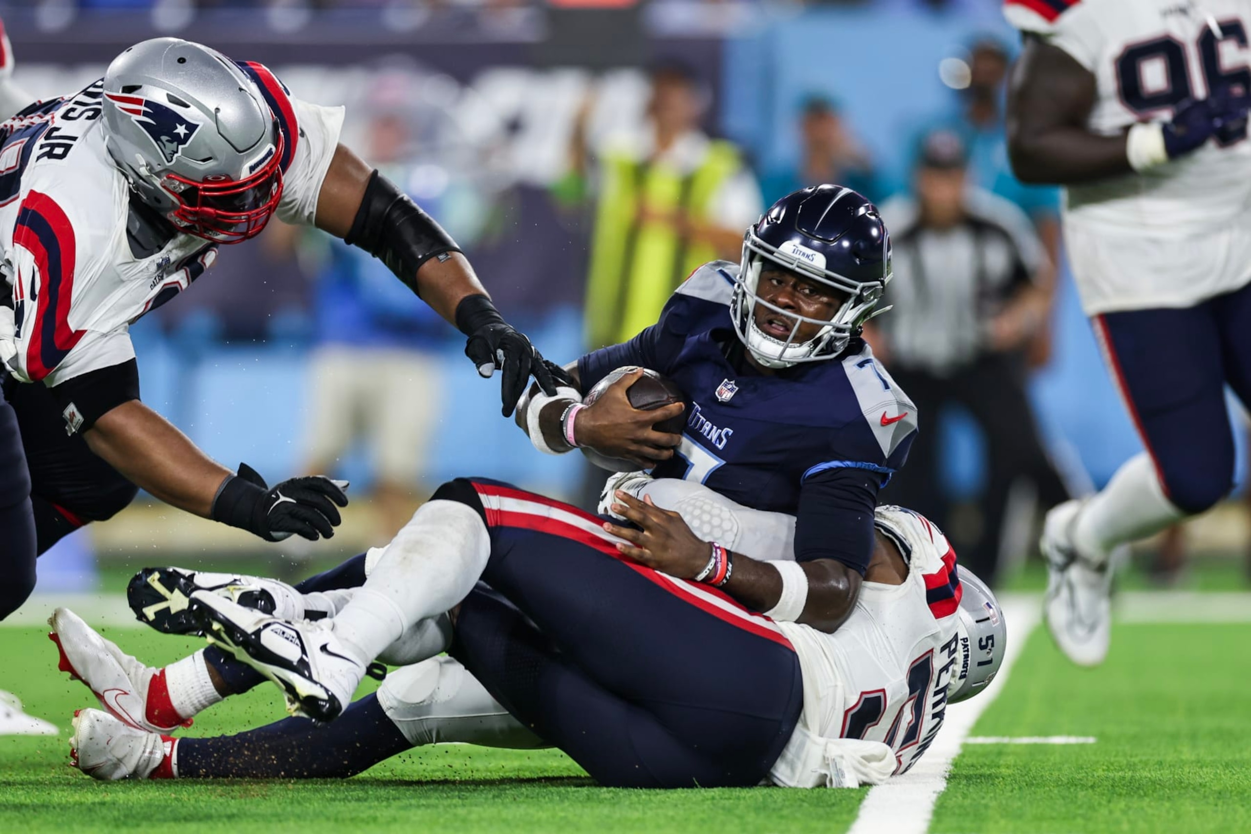 NASHVILLE, TENNESSEE - AUGUST 25: Malik Willis #7 of the Tennessee Titans is sacked by the New England Patriots during the preseason game at Nissan Stadium on August 25, 2023 in Nashville, Tennessee. (Photo by Silas Walker/Getty Images)