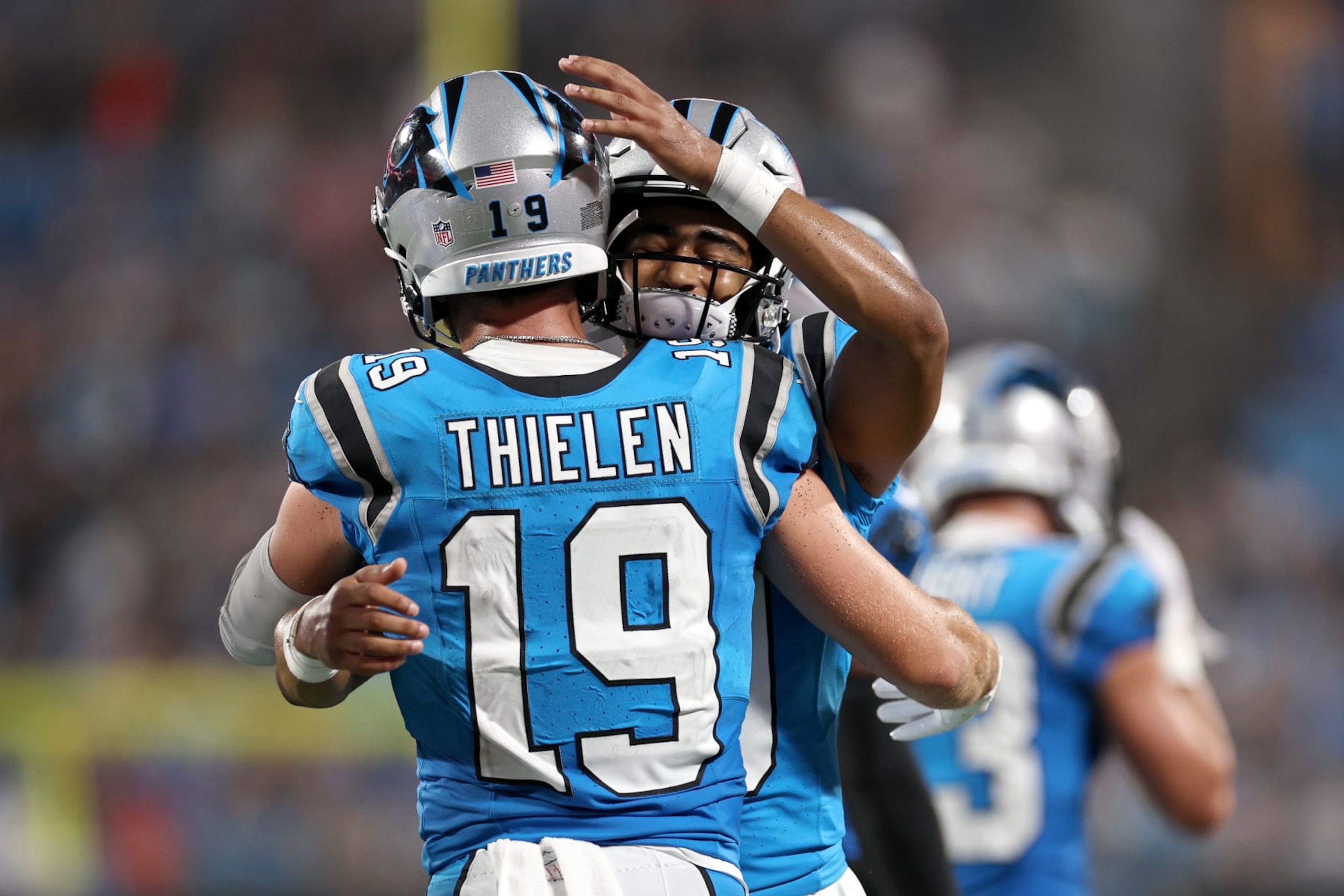 Bryce Young celebrates his first NFL touchdown throw with Adam Thielen.