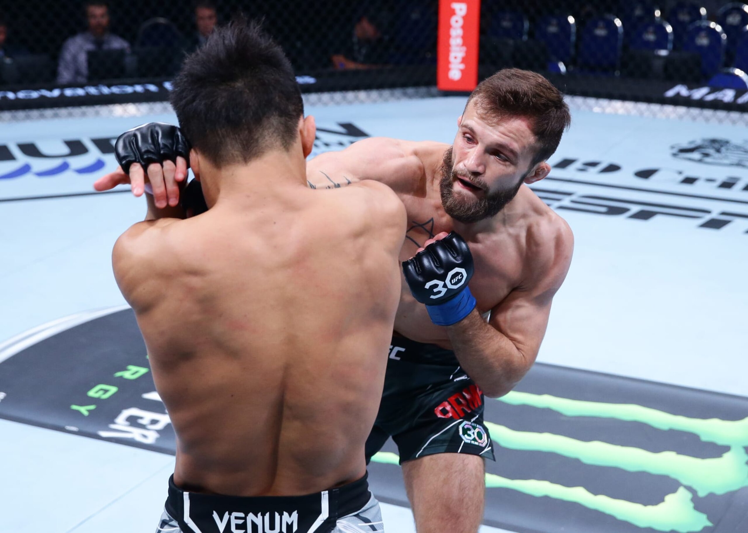 SINGAPORE, SINGAPORE - AUGUST 26: (R-L) Garrett Armfield punches Toshiomi Kazama of Japan in a bantamweight bout during the UFC Fight Night event at Singapore Indoor Stadium on August 26, 2023 in Singapore. (Photo by Suhaimi Abdullah/Zuffa LLC via Getty Images)