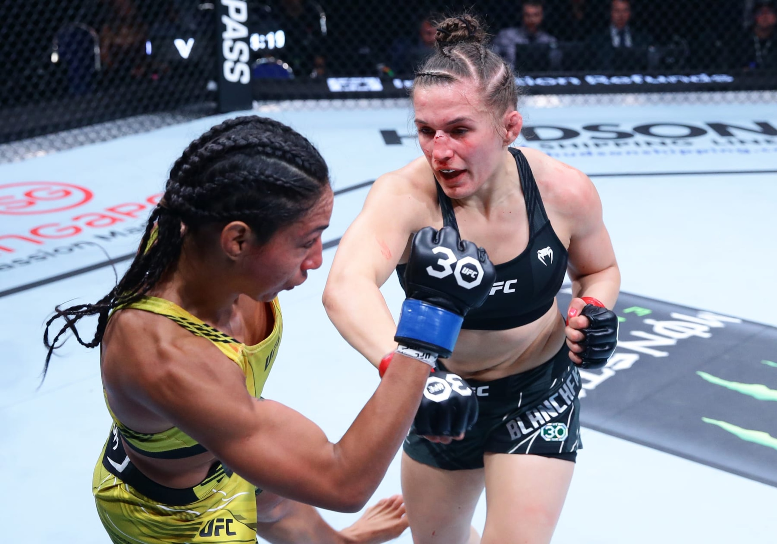 SINGAPORE, SINGAPORE - AUGUST 26: (R-L) Erin Blanchfield punches Taila Santos of Brazil in a flyweight bout during the UFC Fight Night event at Singapore Indoor Stadium on August 26, 2023 in Singapore. (Photo by Suhaimi Abdullah/Zuffa LLC via Getty Images)