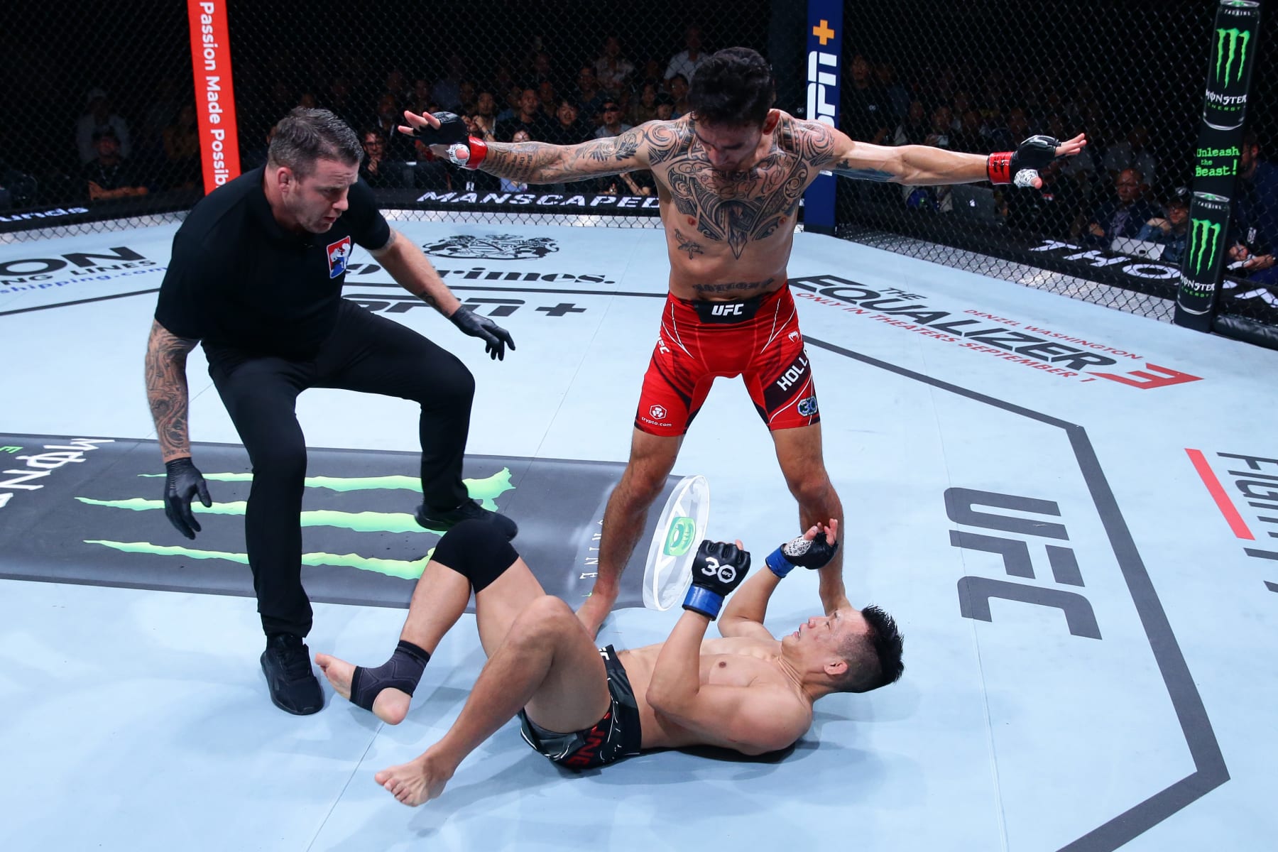 SINGAPORE, SINGAPORE - AUGUST 26: Max Holloway stands over Chan Sung Jung of South Korea after a knockdown in a featherweight bout during the UFC Fight Night event at Singapore Indoor Stadium on August 26, 2023 in Singapore. (Photo by Suhaimi Abdullah/Zuffa LLC via Getty Images)