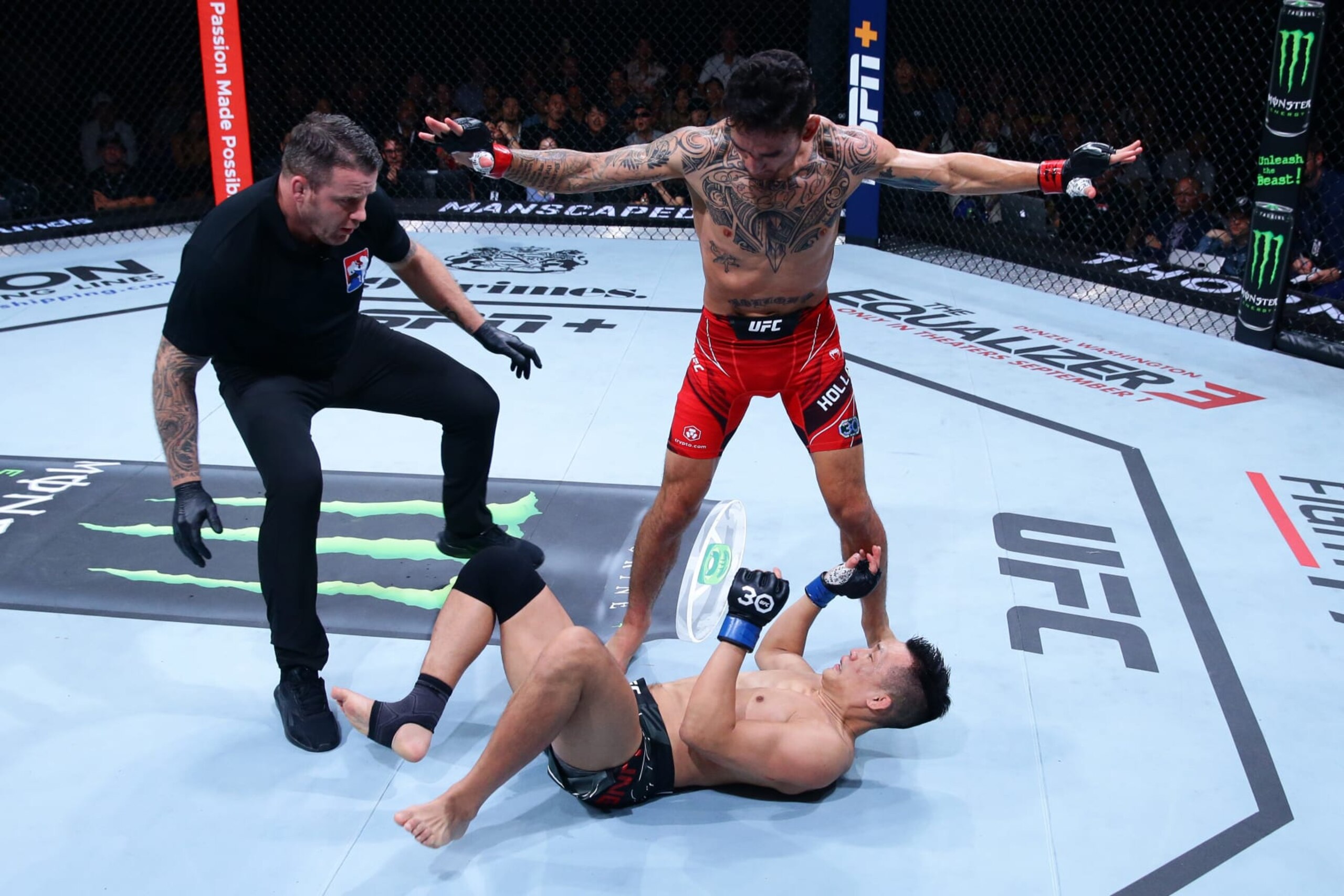 SINGAPORE, SINGAPORE - AUGUST 26: Max Holloway stands over Chan Sung Jung of South Korea after a knockdown in a featherweight bout during the UFC Fight Night event at Singapore Indoor Stadium on August 26, 2023 in Singapore. (Photo by Suhaimi Abdullah/Zuffa LLC via Getty Images)