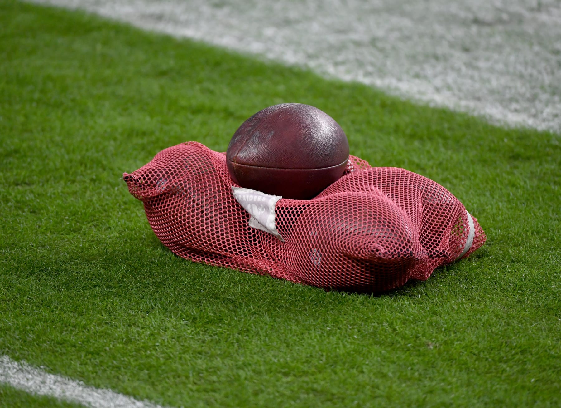 LAS VEGAS, NEVADA - DECEMBER 17:  A mesh bag of footballs is shown on the Las Vegas Raiders sideline before the team's game against the Los Angeles Chargers at Allegiant Stadium on December 17, 2020 in Las Vegas, Nevada. The Chargers defeated the Raiders 30-27 in overtime.  (Photo by Ethan Miller/Getty Images)