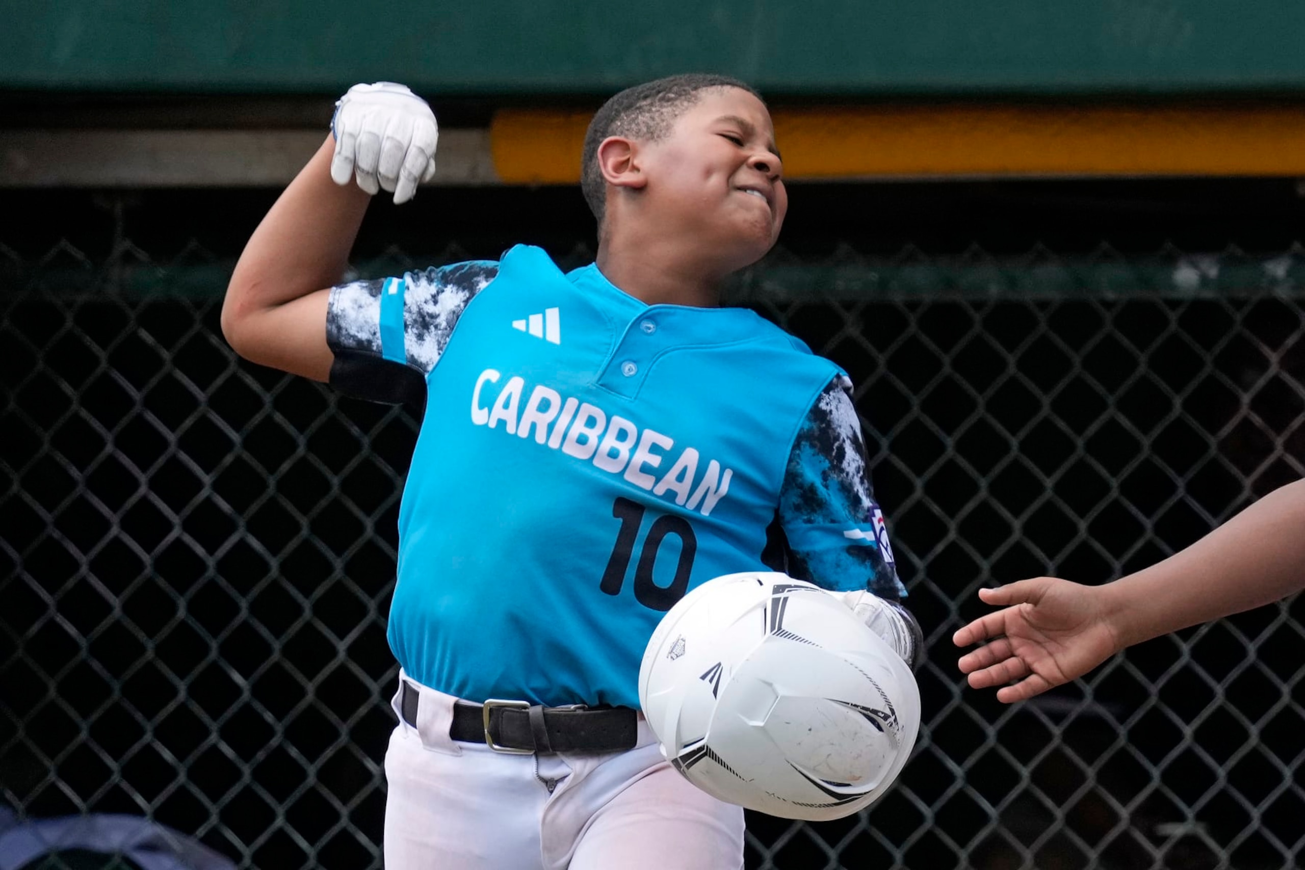Curacao's Jay-Dlynn Wiel celebrates after scoring during the fourth inning of the International Championship baseball game against Taiwan at the Little League World Series tournament in South Williamsport, Pa., Saturday, Aug. 26, 2023. (AP Photo/Gene J. Puskar)