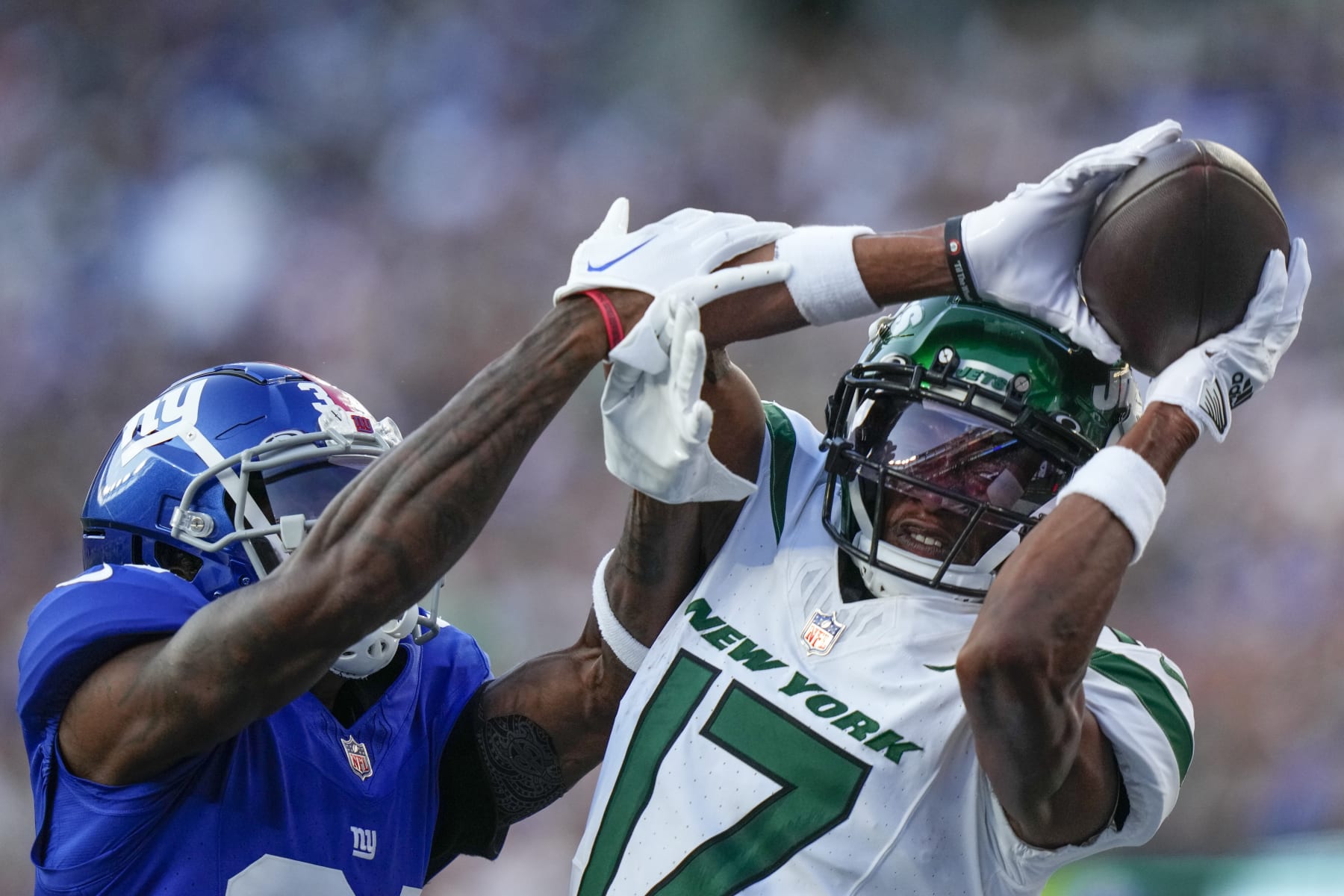 New York Jets wide receiver Garrett Wilson (17) catches a pass against New York Giants cornerback Gemon Green (34) during the first half of an NFL preseason football game, Saturday, Aug. 26, 2023, in East Rutherford, N.J. (AP Photo/Frank Franklin II)