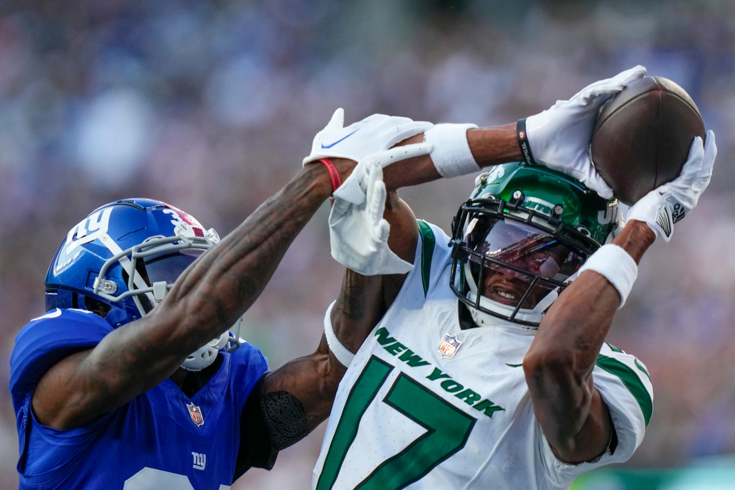 New York Jets wide receiver Garrett Wilson (17) catches a pass against New York Giants cornerback Gemon Green (34) during the first half of an NFL preseason football game, Saturday, Aug. 26, 2023, in East Rutherford, N.J. (AP Photo/Frank Franklin II)