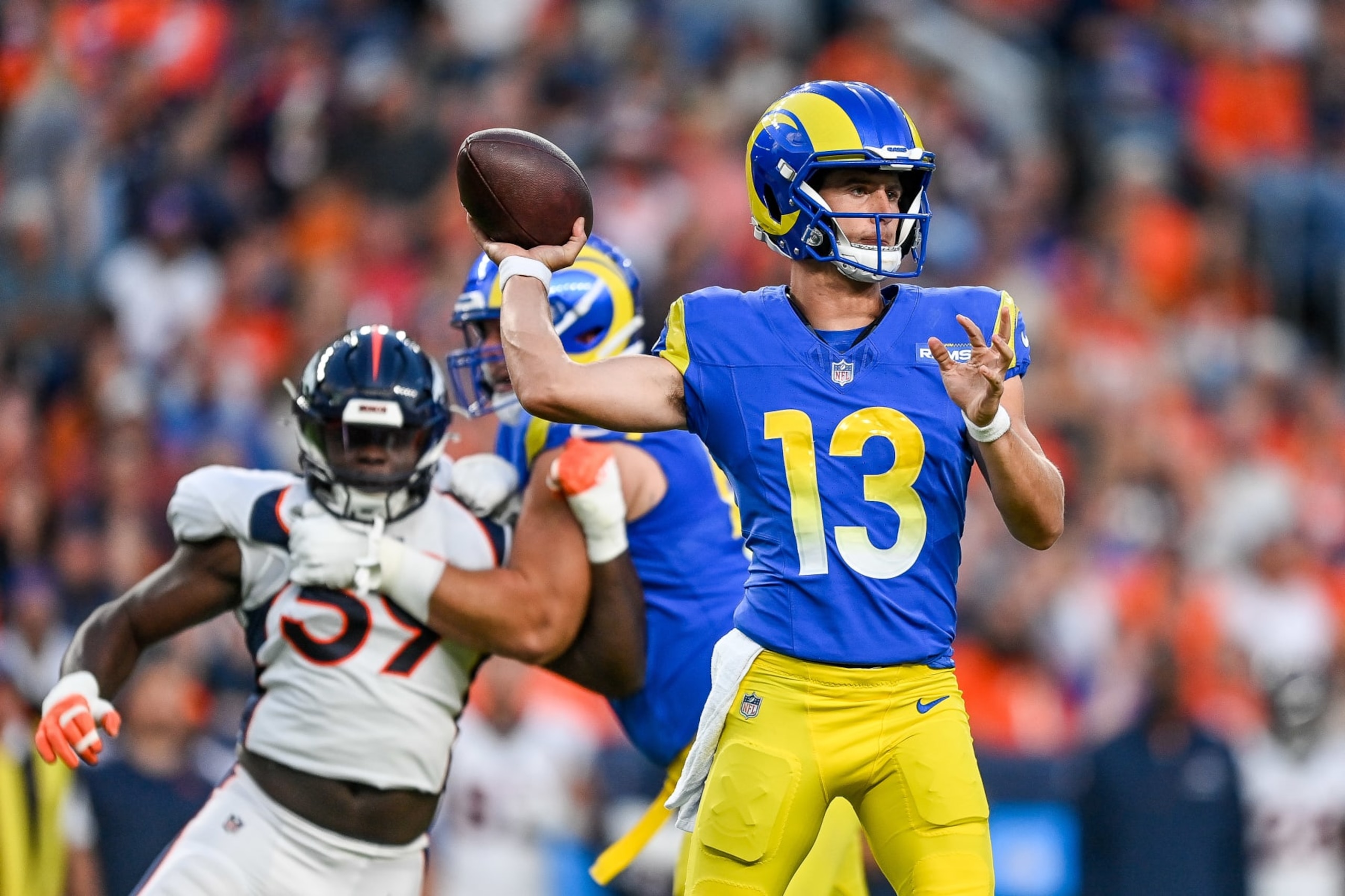 DENVER, COLORADO - AUGUST 26:  Quarterback Stetson Bennett #13 of the Los Angeles Rams passes in the first quarter against the Denver Broncos in a preseason game at Empower Field at Mile High on August 26, 2023 in Denver, Colorado. (Photo by Dustin Bradford/Getty Images)