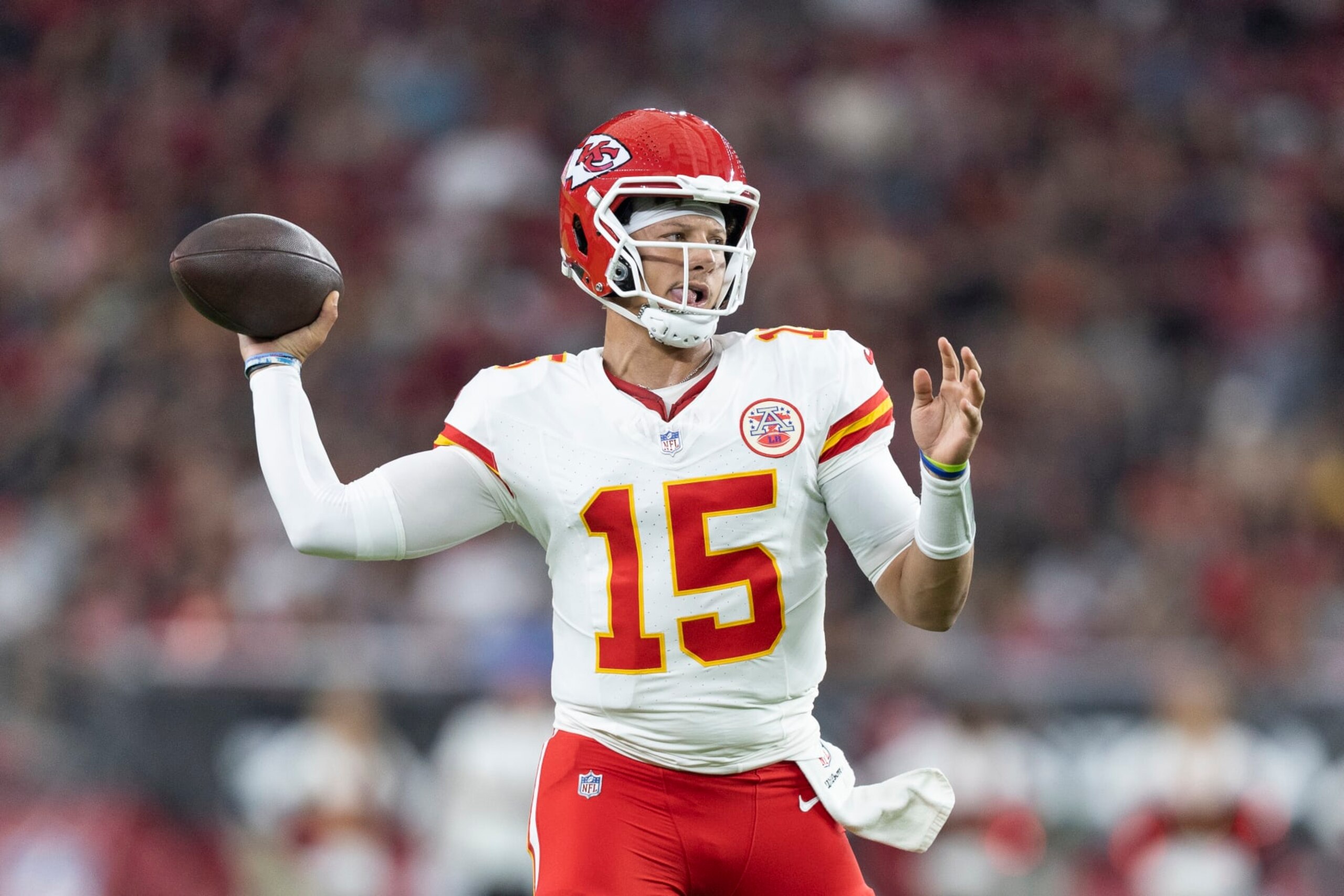 GLENDALE, ARIZONA - AUGUST 19: Patrick Mahomes #15 of the Kansas City Chiefs scrambles and passes for a touchdown during an NFL preseason football game between the Arizona Cardinals and the Kansas City Chiefs at State Farm Stadium on August 19, 2023 in Glendale, Arizona. (Photo by Michael Owens/Getty Images)