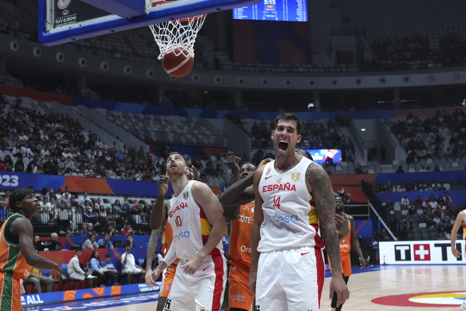 Spain center Willy Hernangomez (14) reacts as he scores against Cote d'Ivoire during the Basketball World Cup group G match between Spain and Cote d'Ivoire at the Indonesia Arena stadium in Jakarta, Indonesia, Saturday, Aug. 26, 2023. (AP Photo/Achmad Ibrahim)