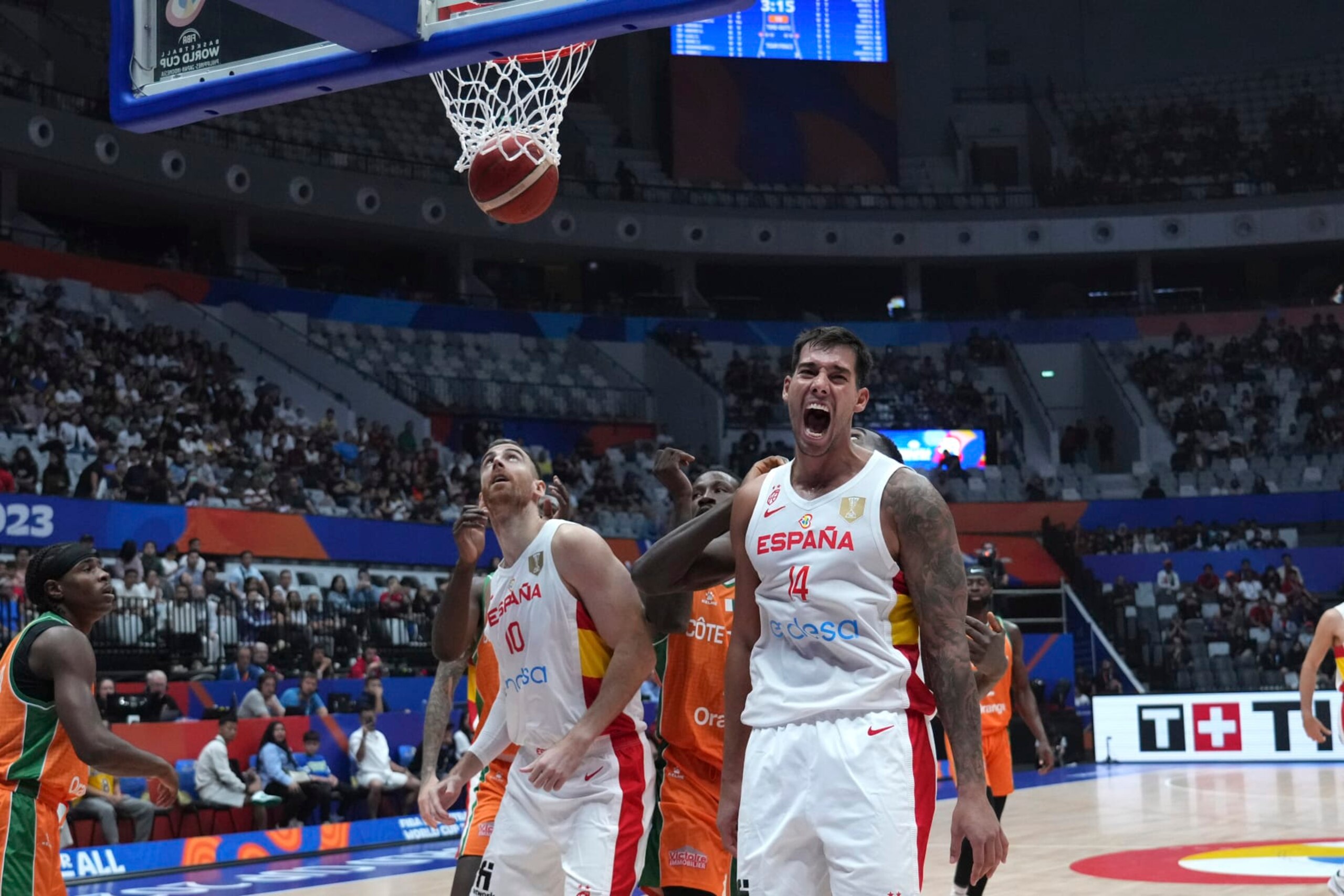 Spain center Willy Hernangomez (14) reacts as he scores against Cote d'Ivoire during the Basketball World Cup group G match between Spain and Cote d'Ivoire at the Indonesia Arena stadium in Jakarta, Indonesia, Saturday, Aug. 26, 2023. (AP Photo/Achmad Ibrahim)