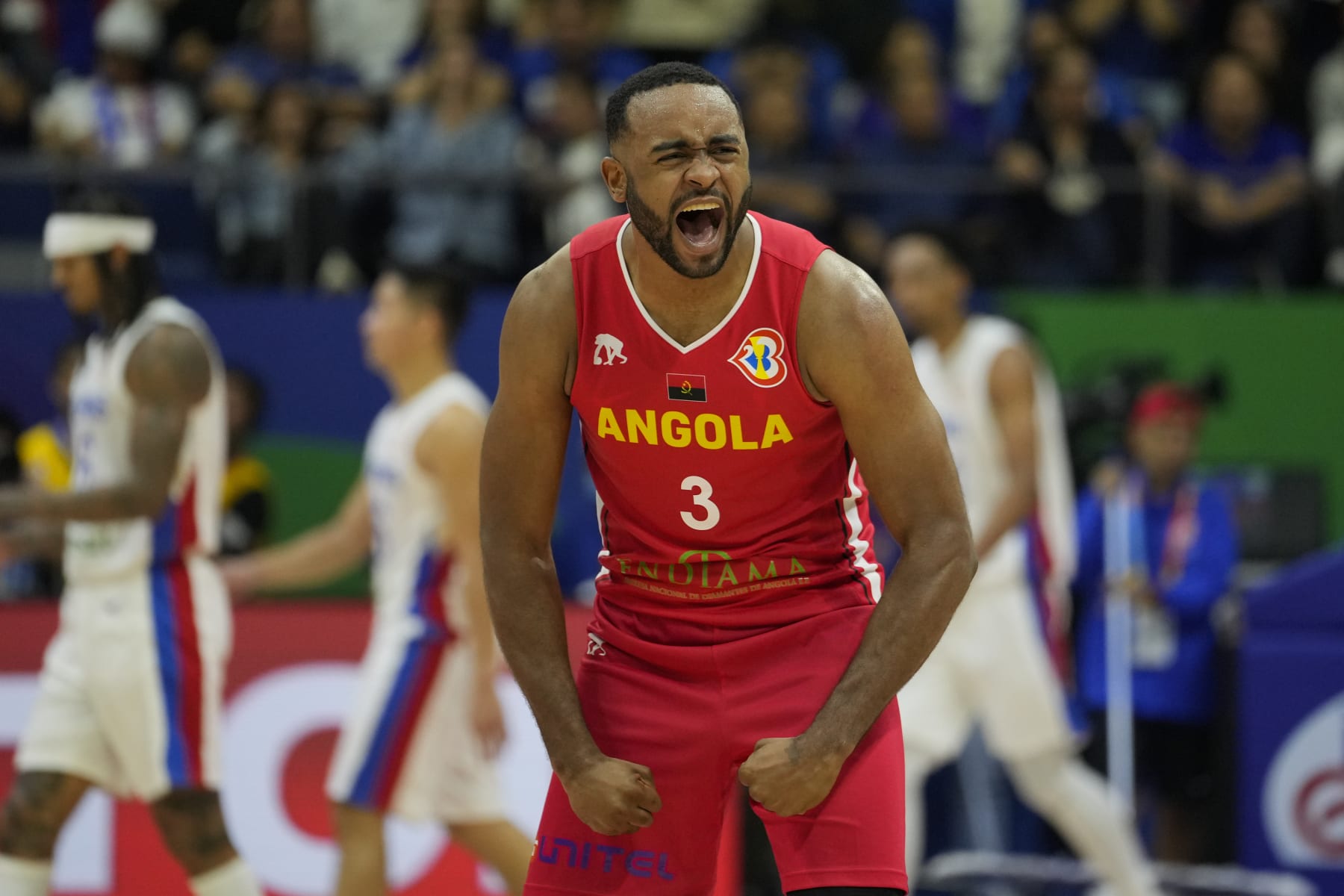 Angola guard Gerson Goncalves (3) celebrate after their win against the Philippines during their Basketball World Cup group A match at the Araneta Coliseum in Manila, Philippines Sunday, Aug. 27, 2023. (AP Photo/Aaron Favila)