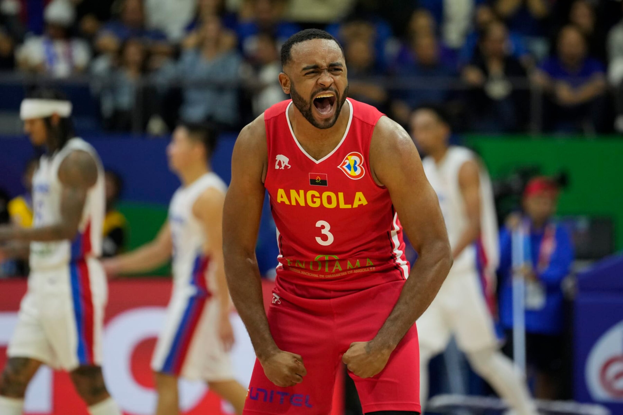 Angola guard Gerson Goncalves (3) celebrate after their win against the Philippines during their Basketball World Cup group A match at the Araneta Coliseum in Manila, Philippines Sunday, Aug. 27, 2023. (AP Photo/Aaron Favila)