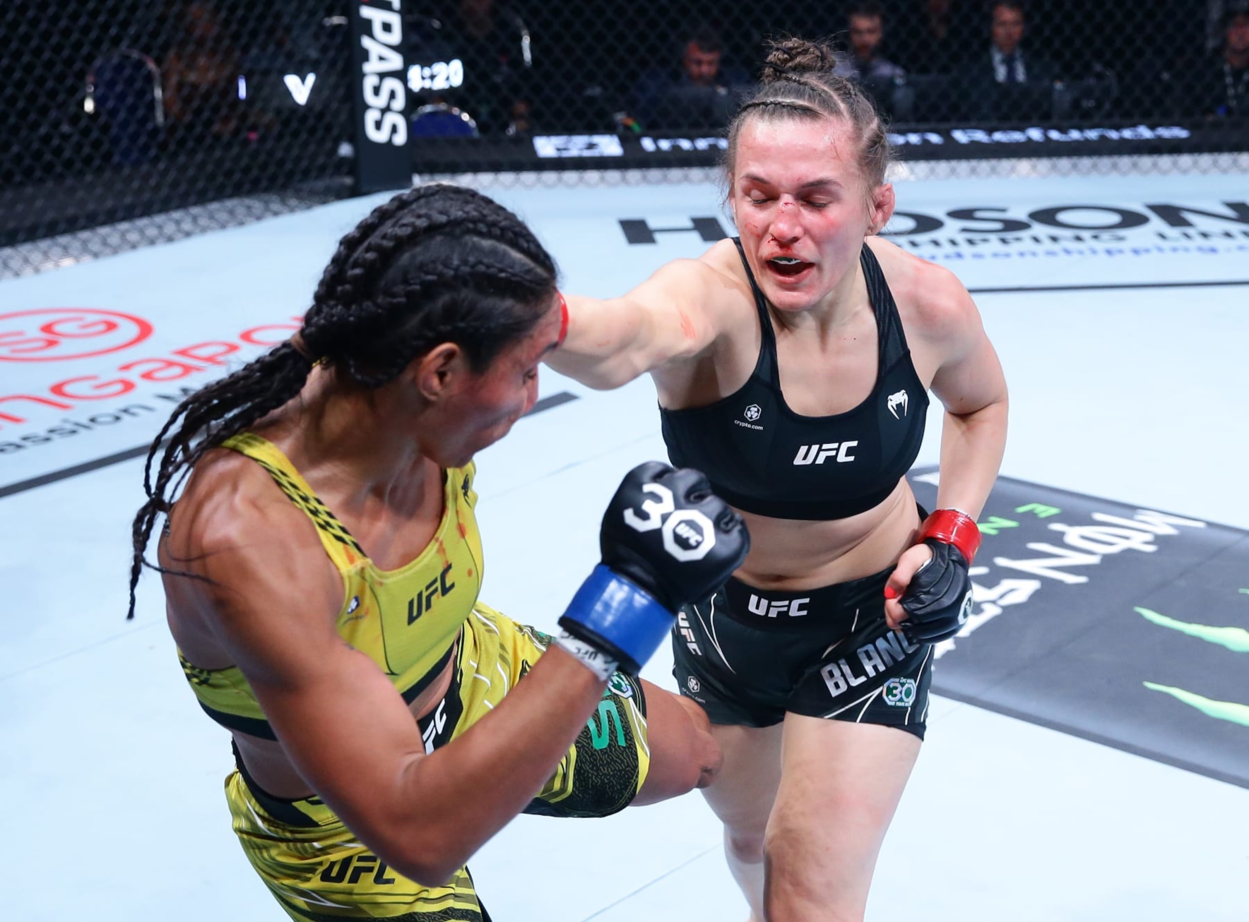 SINGAPORE, SINGAPORE - AUGUST 26: (R-L) Erin Blanchfield punches Taila Santos of Brazil in a flyweight bout during the UFC Fight Night event at Singapore Indoor Stadium on August 26, 2023 in Singapore. (Photo by Suhaimi Abdullah/Zuffa LLC via Getty Images)