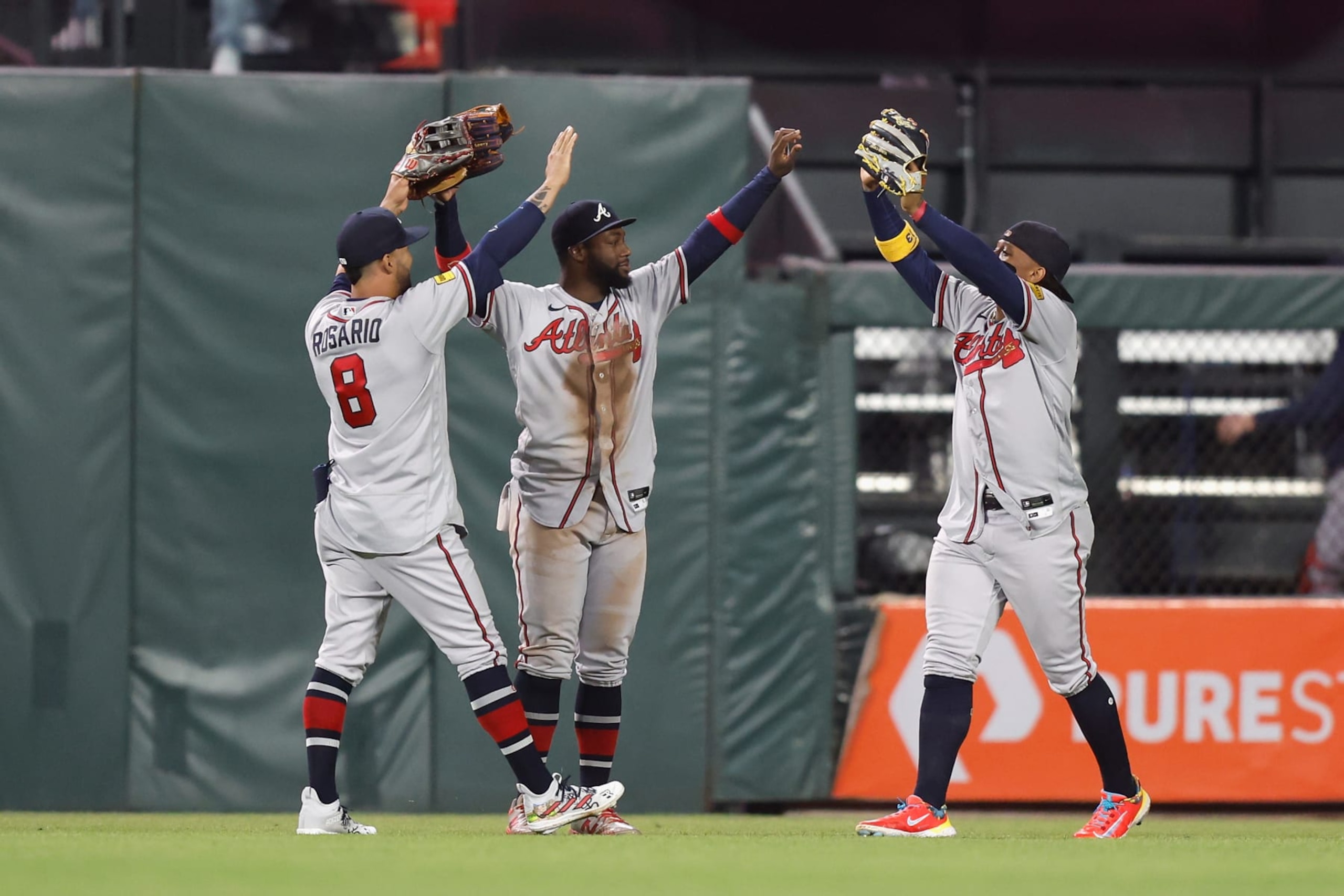 SAN FRANCISCO, CALIFORNIA - AUGUST 25: Eddie Rosario #8, Michael Harris II #23 and Ronald Acuna Jr. #13 of the Atlanta Braves celebrate after a win against the San Francisco Giants at Oracle Park on August 25, 2023 in San Francisco, California. (Photo by Lachlan Cunningham/Getty Images)