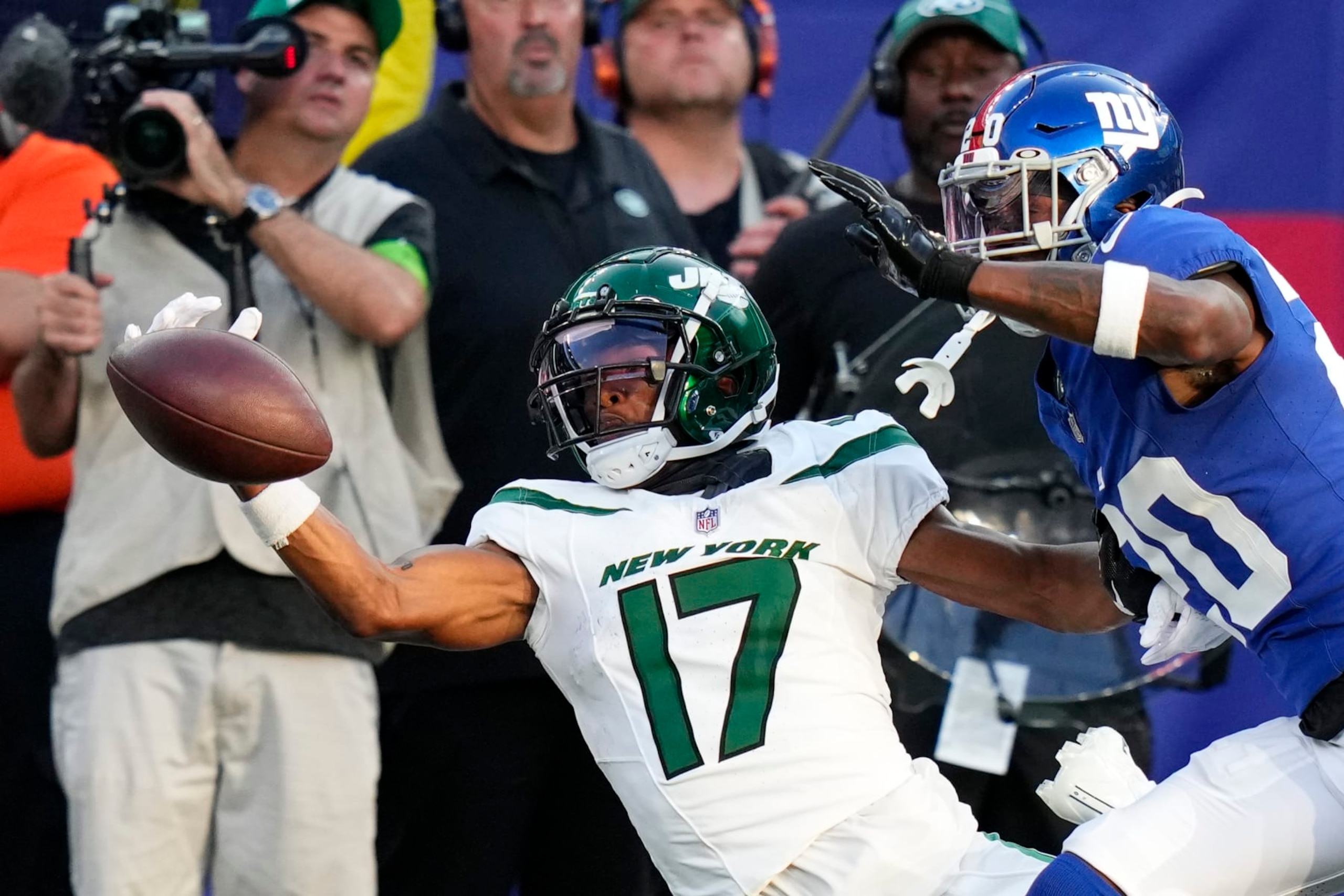 New York Giants cornerback Amani Oruwariye (20) breaks up a pass to New York Jets wide receiver Garrett Wilson (17) during the first half of an NFL preseason football game, Saturday, Aug. 26, 2023, in East Rutherford, N.J. (AP Photo/Frank Franklin II)